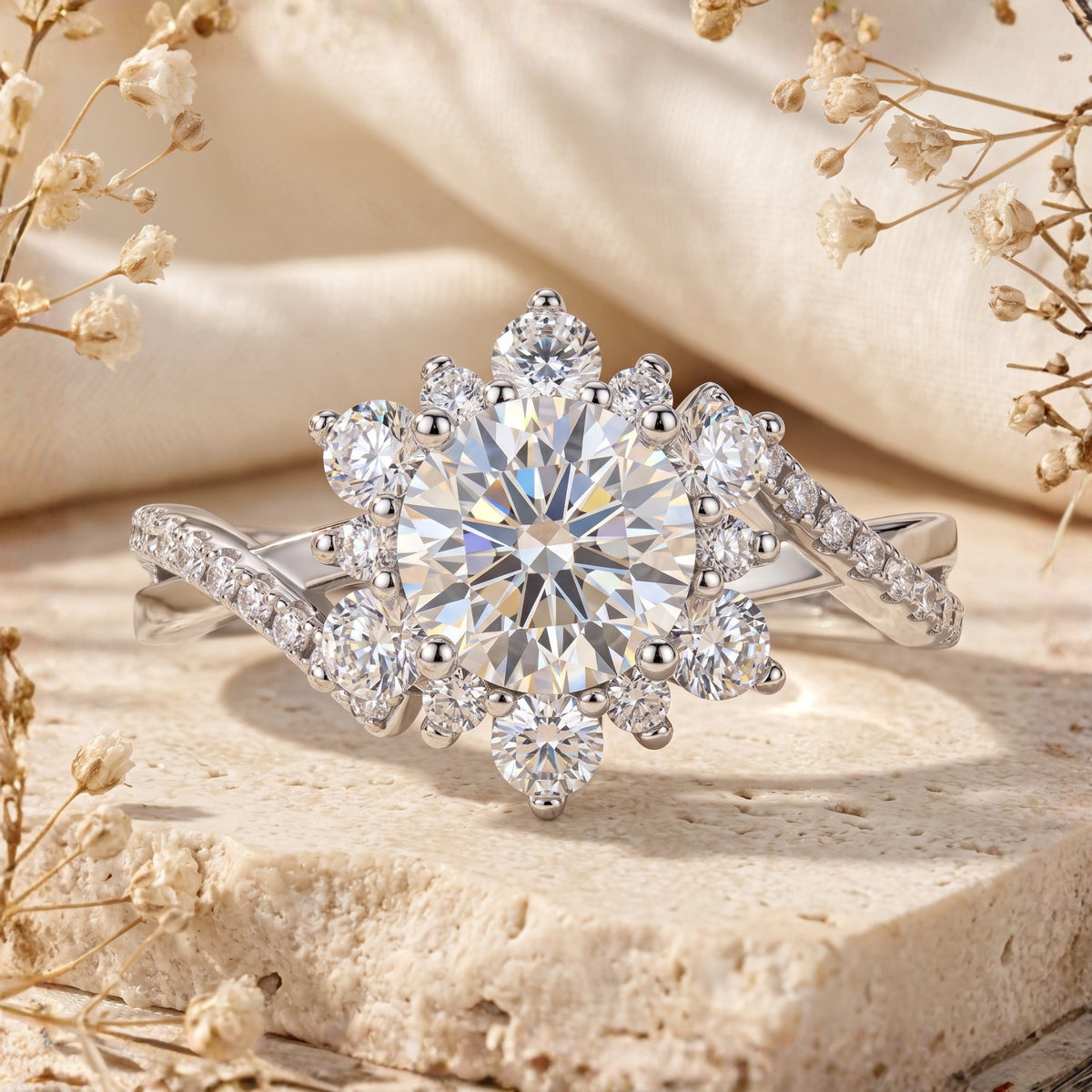 Front view close-up of a silver ring with a round center stone, snowflake halo cluster, and twisted pavé band.