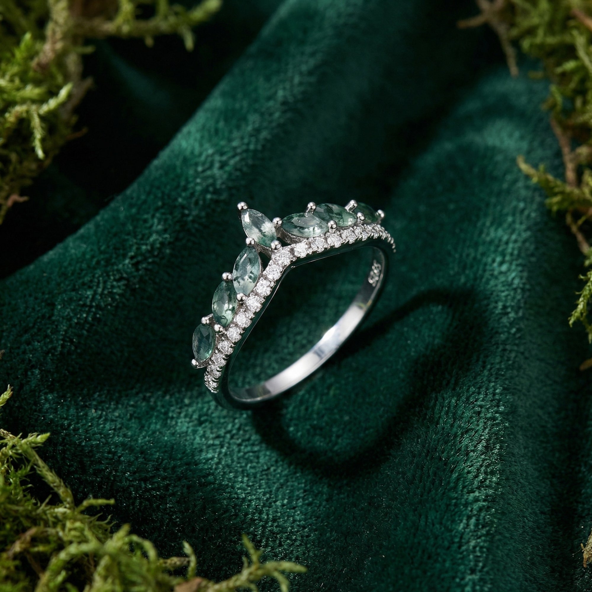 Marquise cut moss agate and diamond wave ring in S925 sterling silver on green velvet with natural moss.