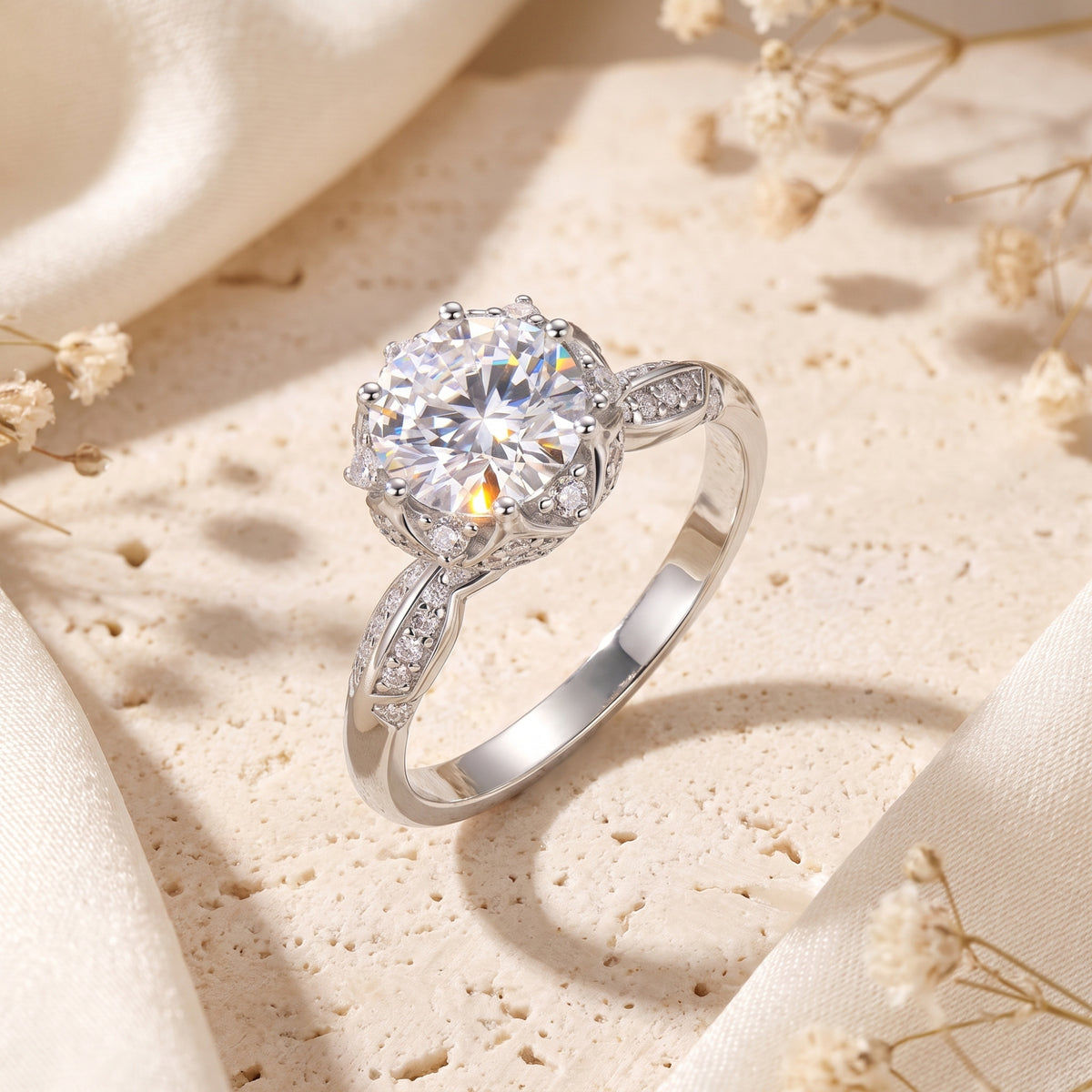 Angled studio view of a silver solitaire ring with a round clear stone in a floral lotus crown setting.