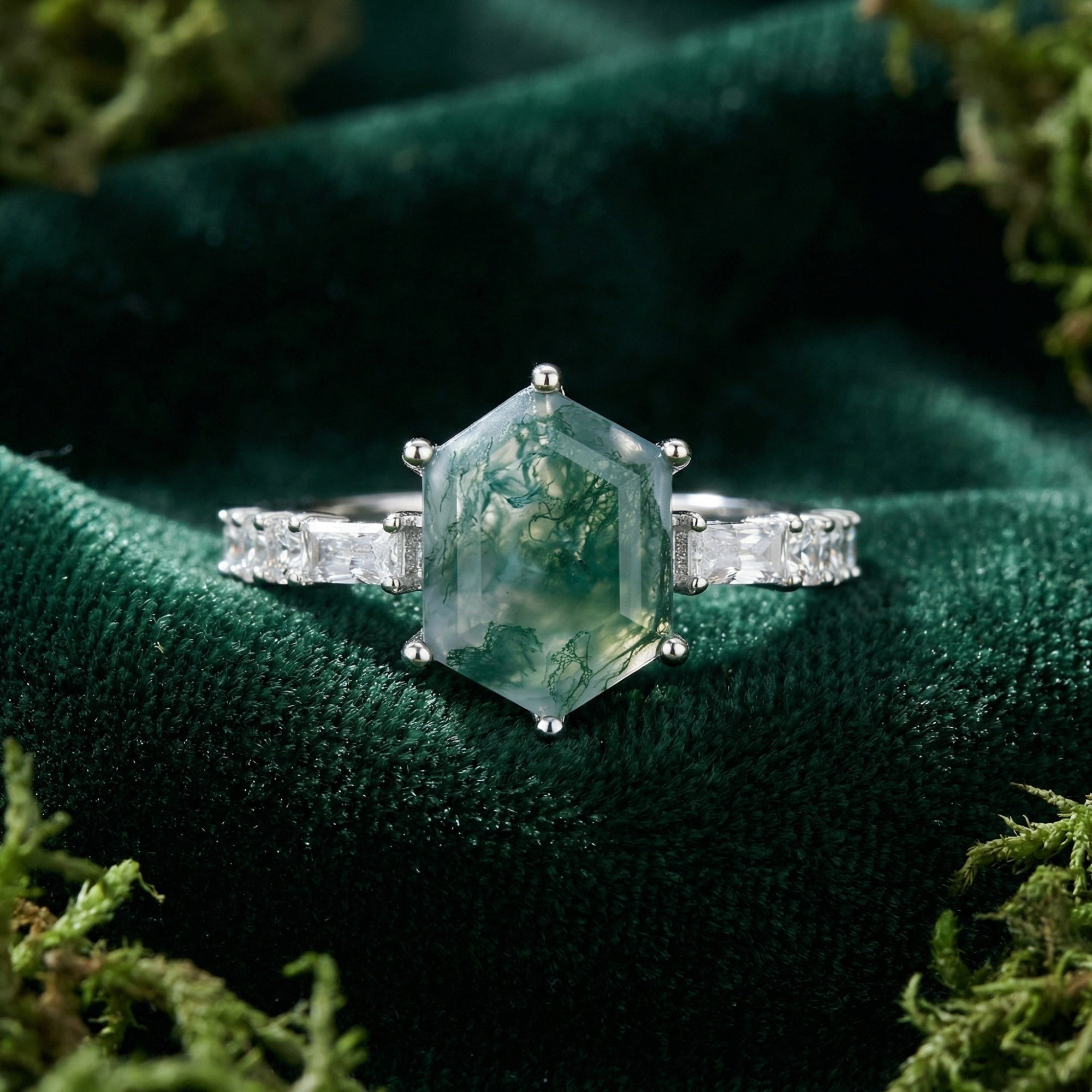 Hexagonal moss agate ring in S925 sterling silver with baguette accents on green velvet and moss.