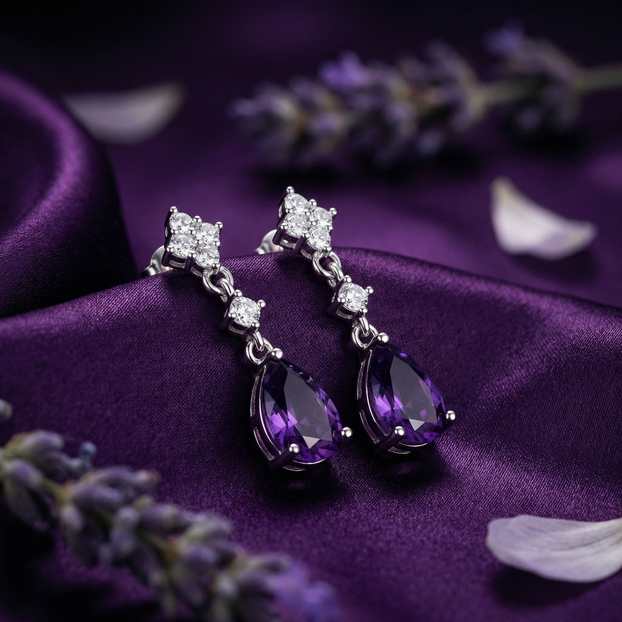 Sterling silver drop earrings with pear cut natural amethyst on purple silk with lavender sprigs.