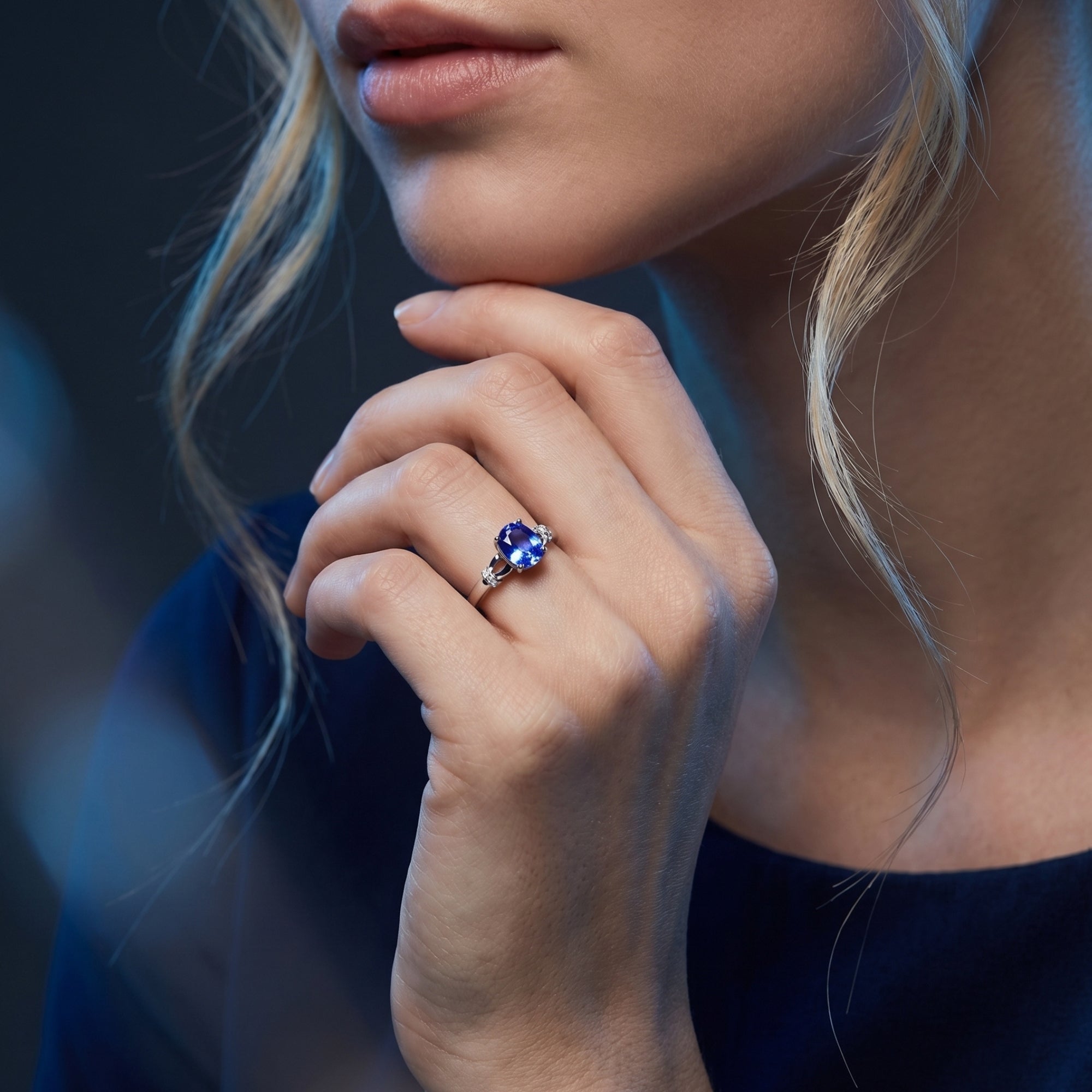 The Illiana oval tanzanite ring in 18K white gold worn on a model's hand to show scale and color.