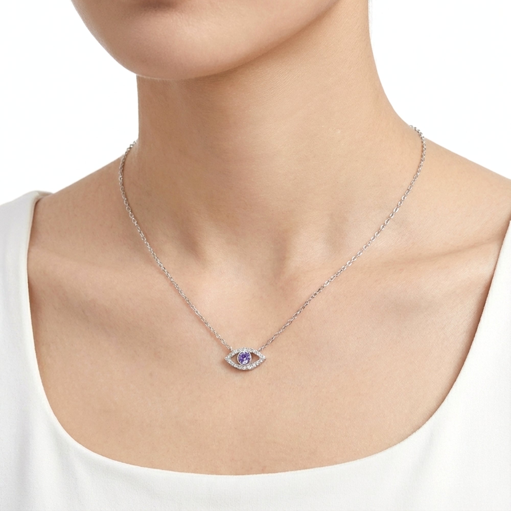 Model wearing the sterling silver Thalira Eye necklace with a round purple amethyst center and moissanite halo.