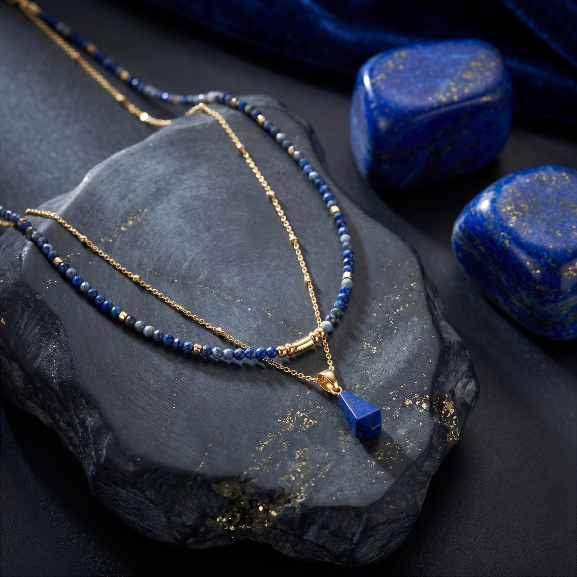 Close-up of the gold layered necklace showing the irregular lapis pendant and faceted blue lapis beads.