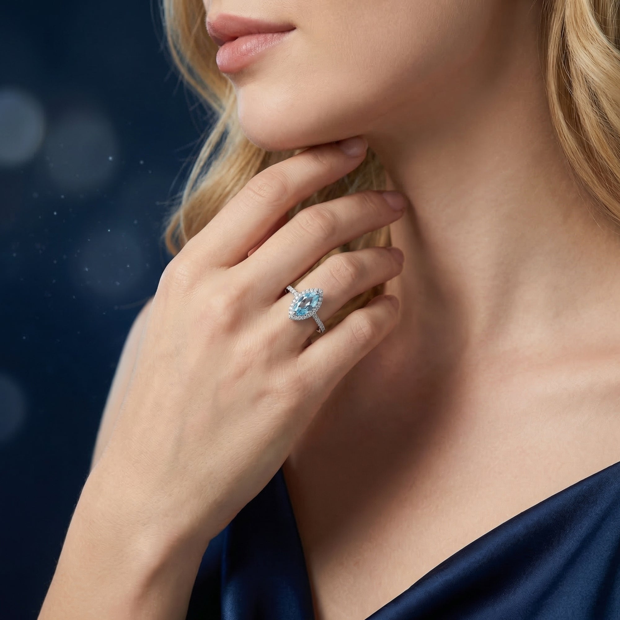 Marquise cut natural blue topaz ring in sterling silver worn by a model, showcasing its size and brilliance on the hand.
