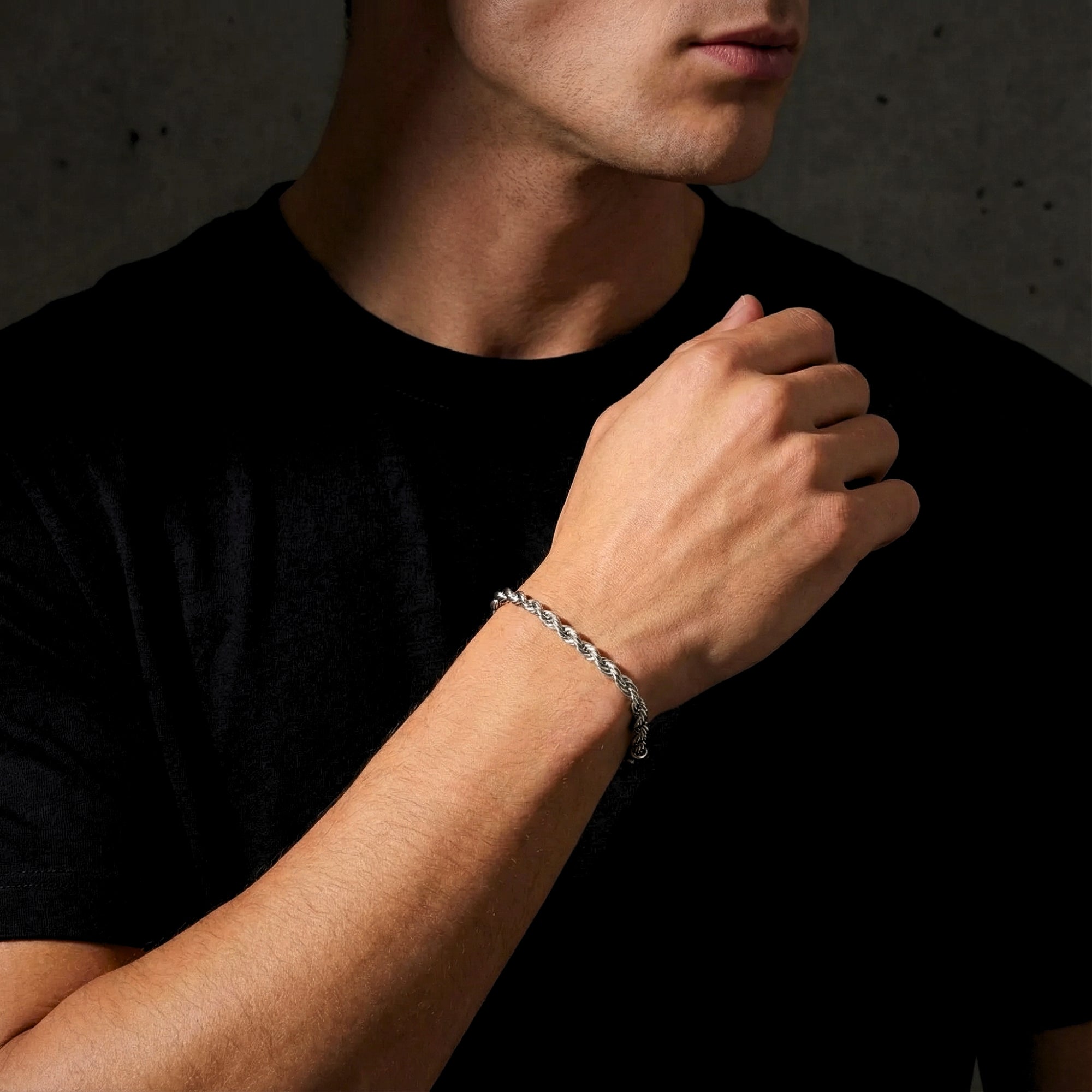Close-up of a silver stainless steel mariner rope bracelet on a man's wrist.