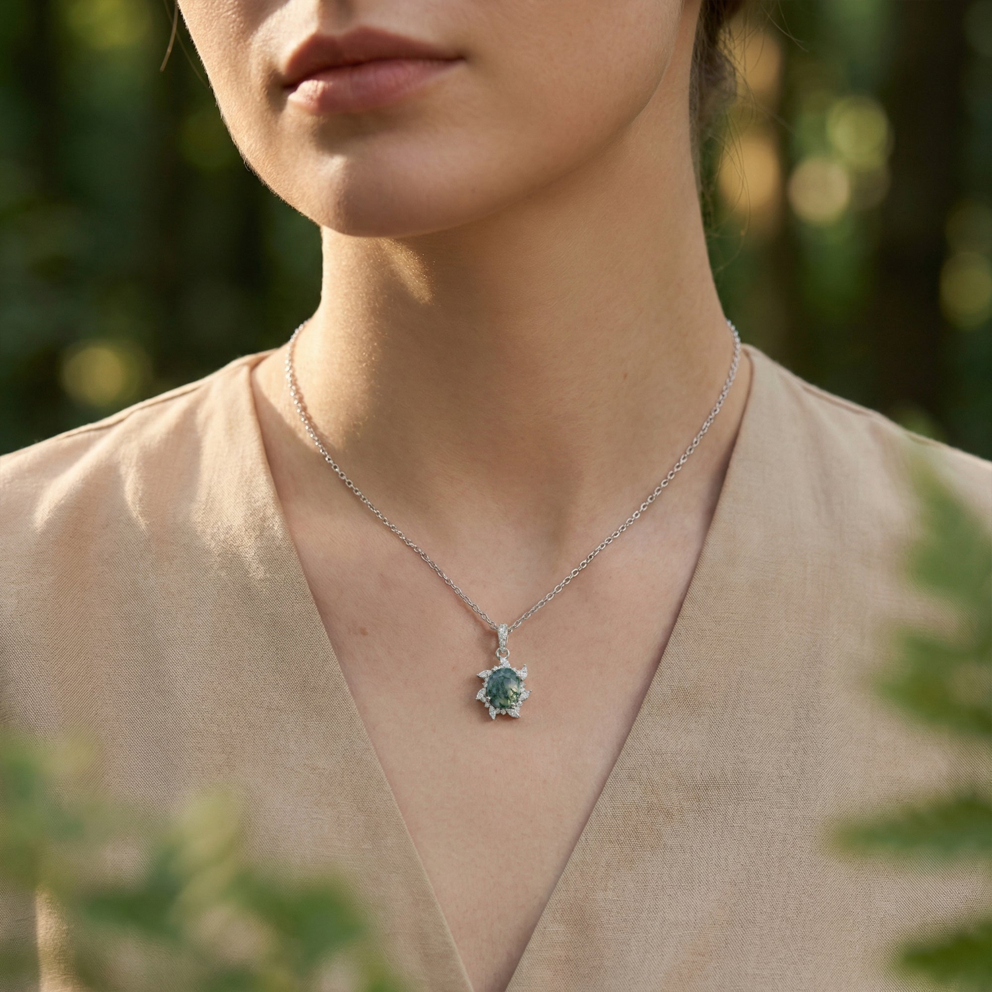 Front view of a model wearing the starburst natural moss agate pendant necklace in S925 sterling silver.