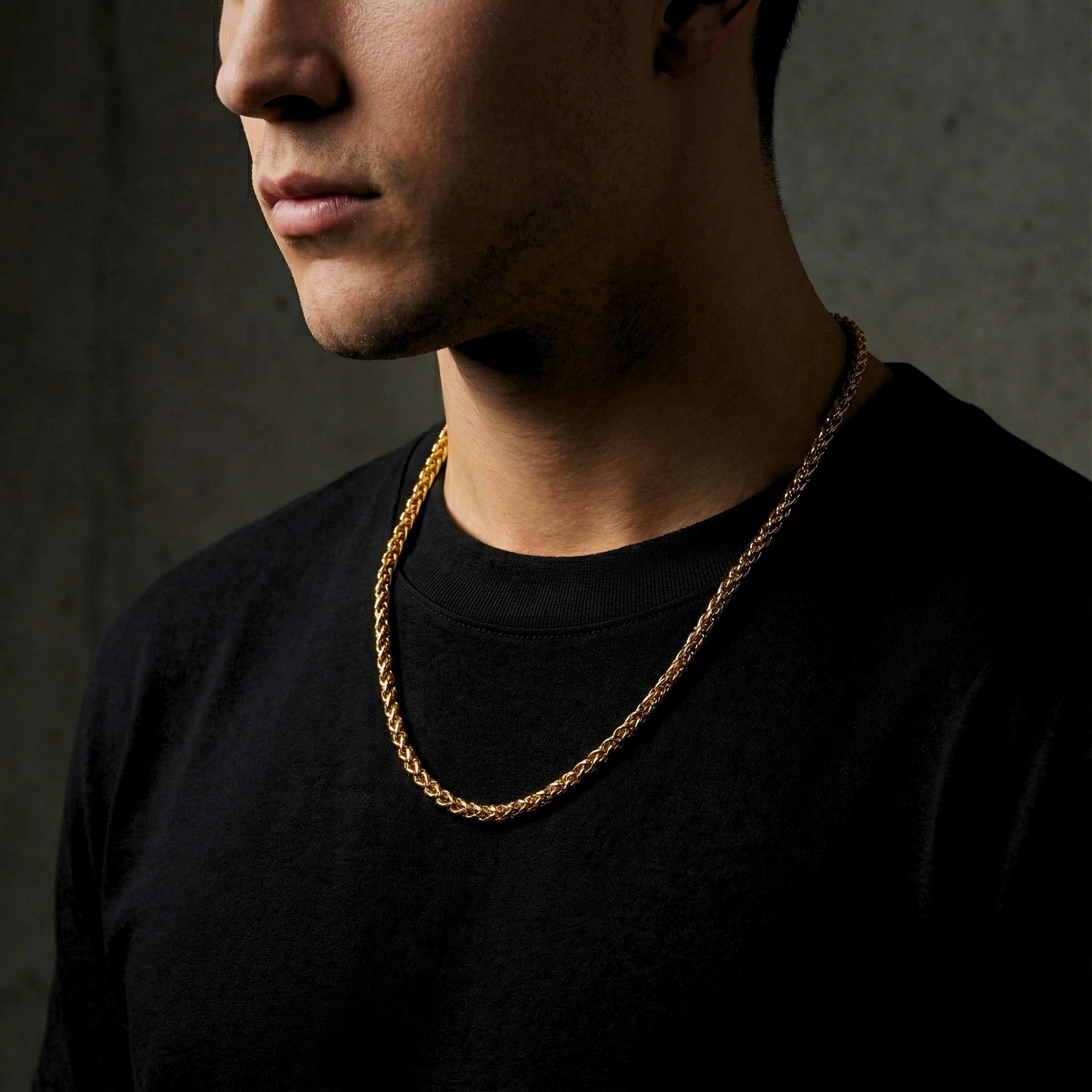 Side profile of a man wearing a 6mm gold stainless steel wheatfield chain.