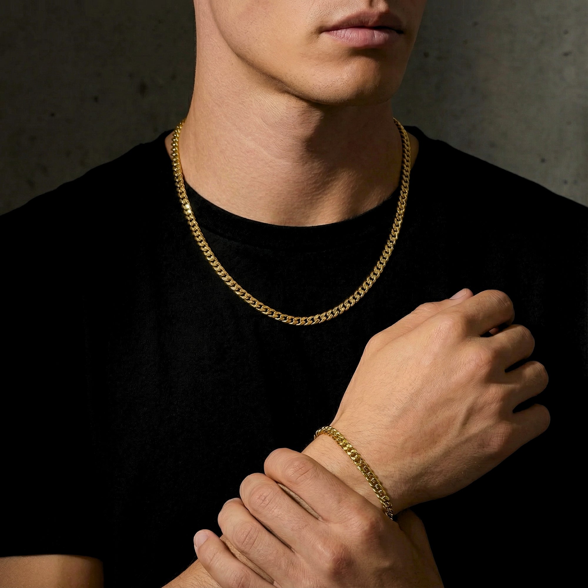 Front view of a man wearing the 6mm gold stainless steel Cuban link chain and bracelet set.