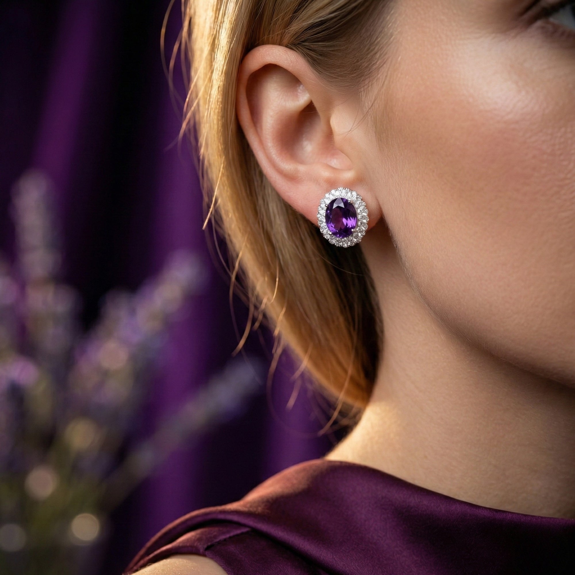 Profile view of a model wearing the Genevra oval natural amethyst halo earring in sterling silver.