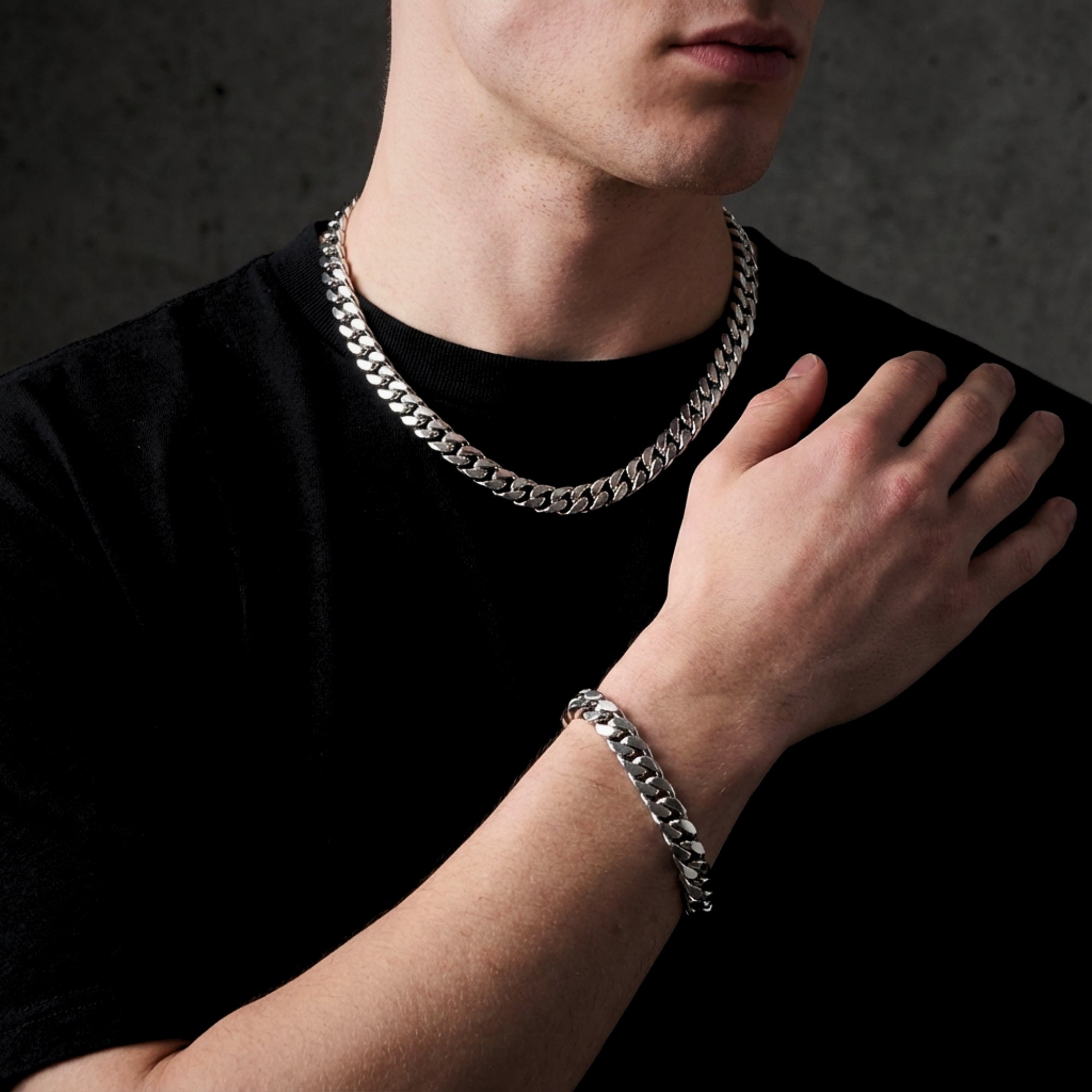 Front view of a man wearing the silver stainless steel Spartan Cuban link chain and bracelet.