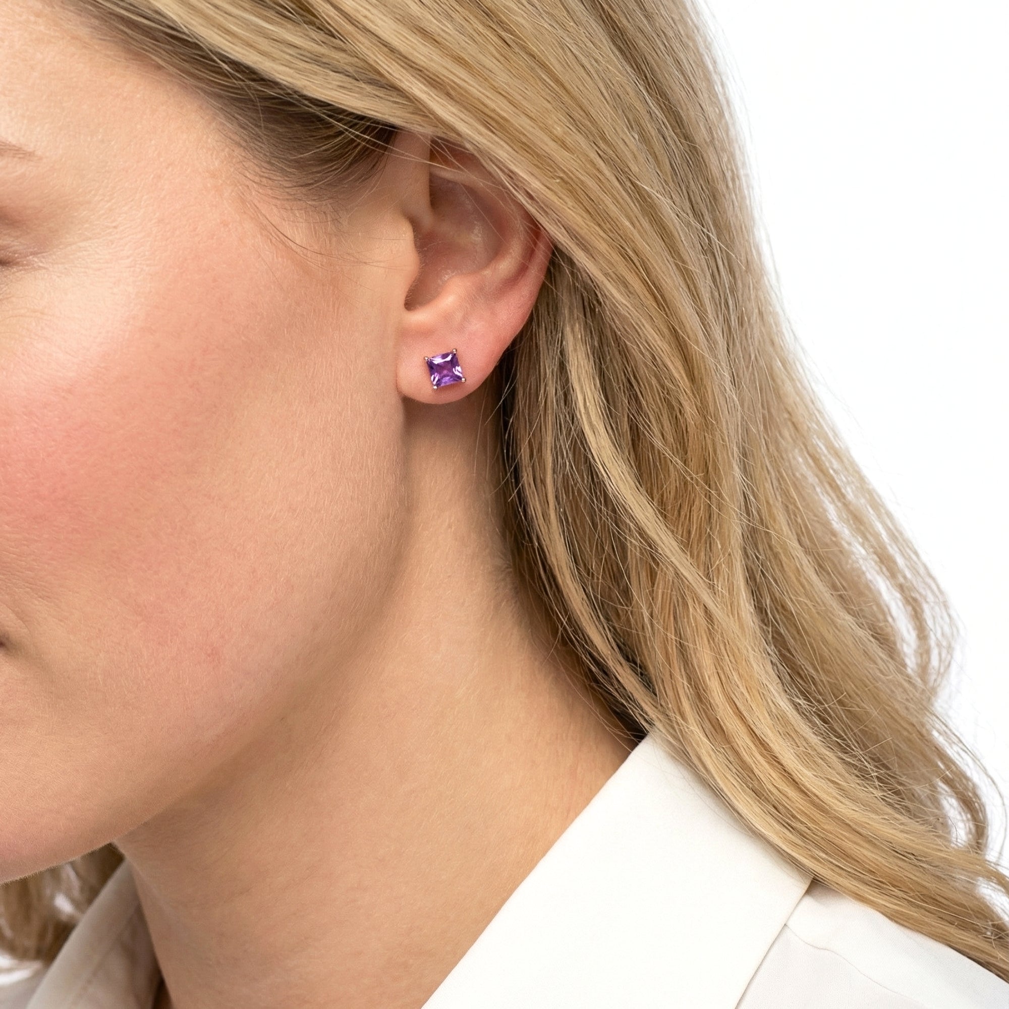 Side profile of a model wearing the square cut simulated amethyst stud earrings in 18K rose gold vermeil.