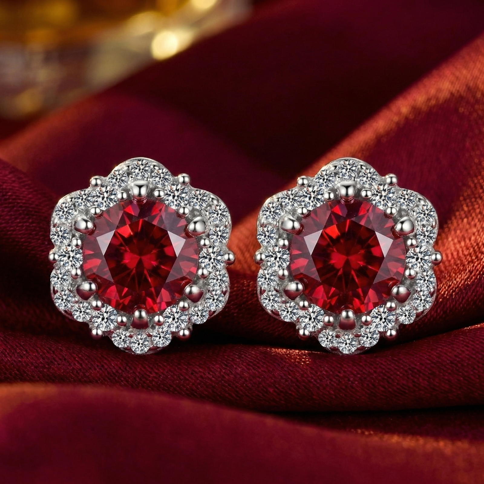 Round-cut pigeon blood red simulated ruby halo stud earrings in S925 sterling silver on red silk.
