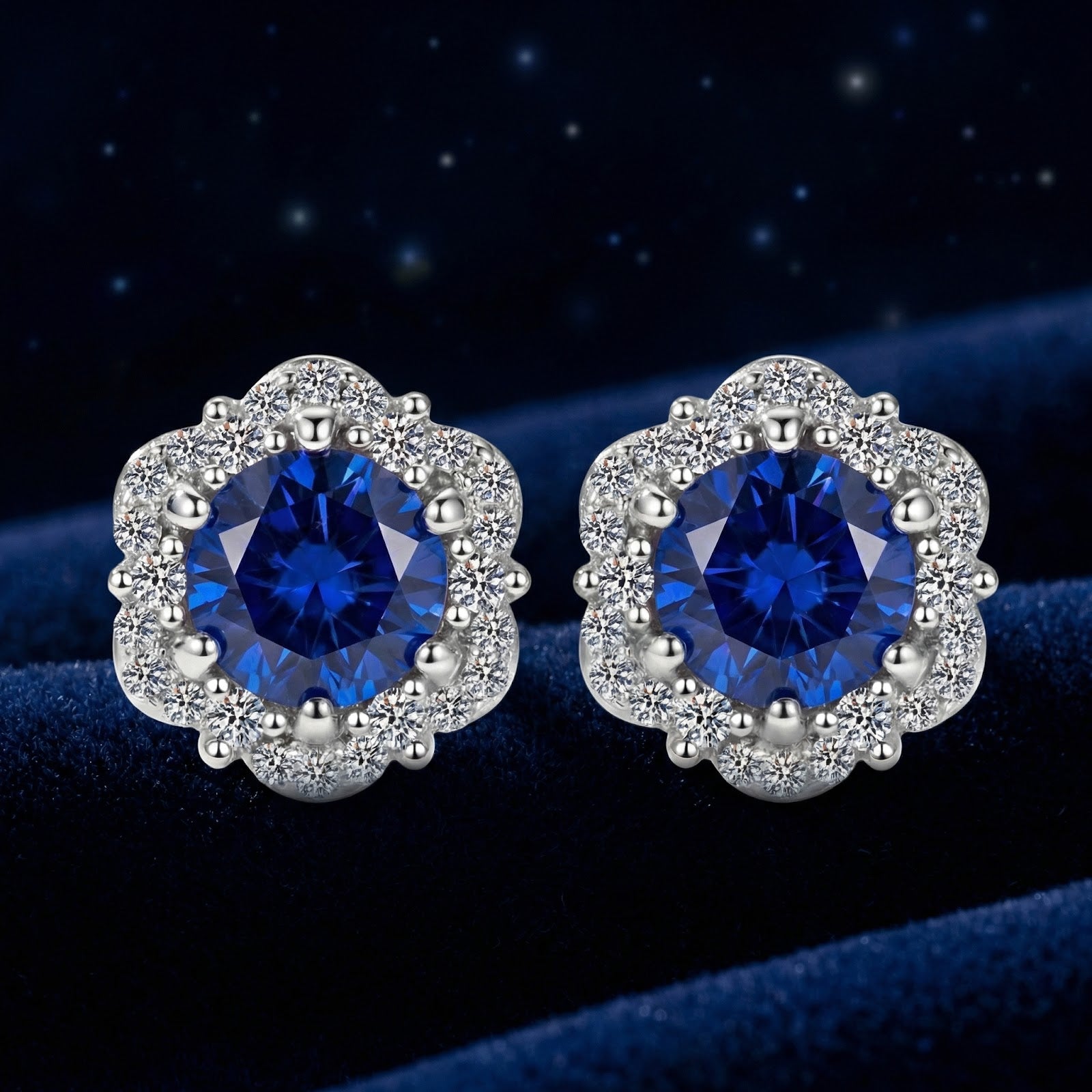 Round cut simulated sapphire halo stud earrings in S925 sterling silver on a dark blue velvet background.