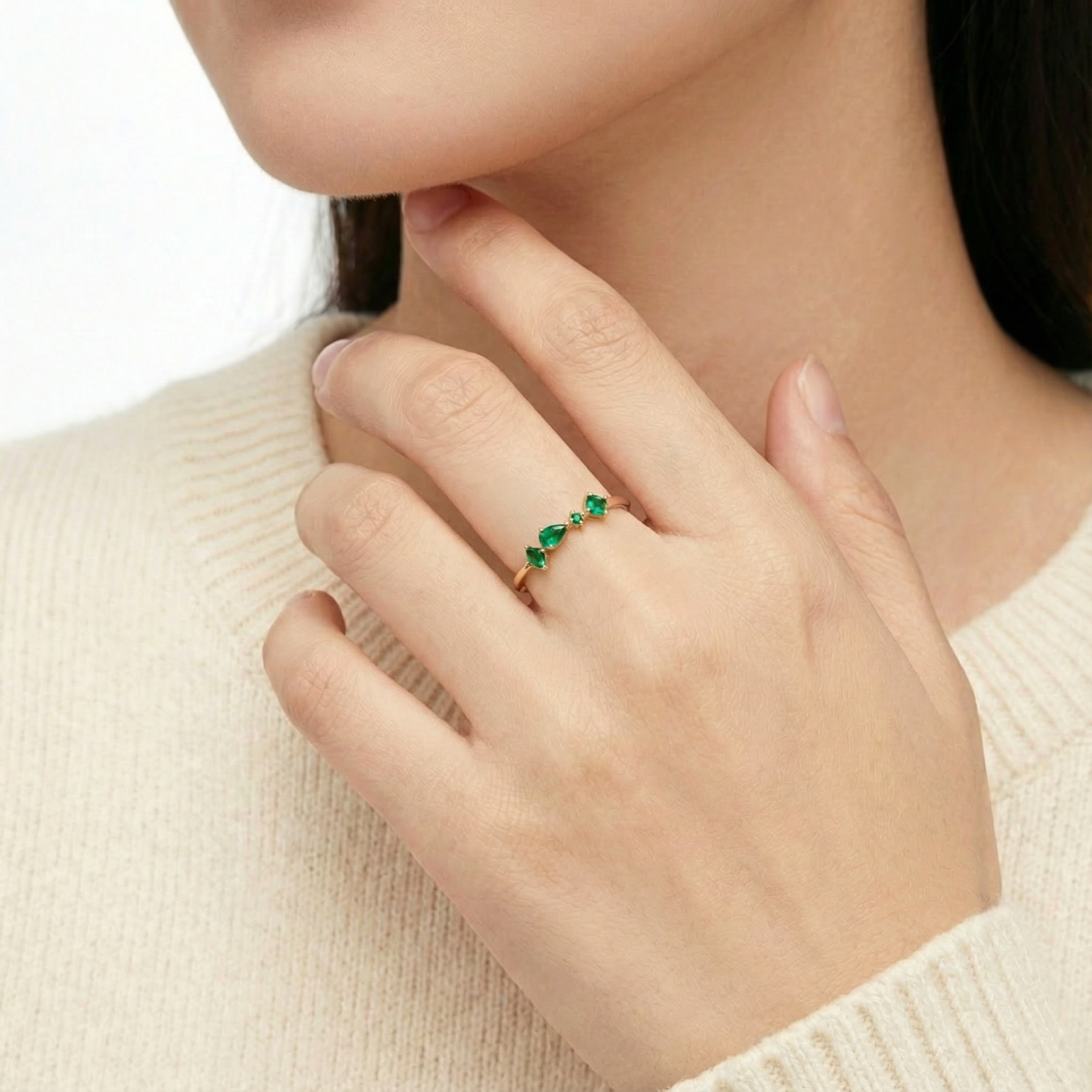 Model wearing the Eldora 18K gold vermeil ring with green simulated emerald cluster on her finger.