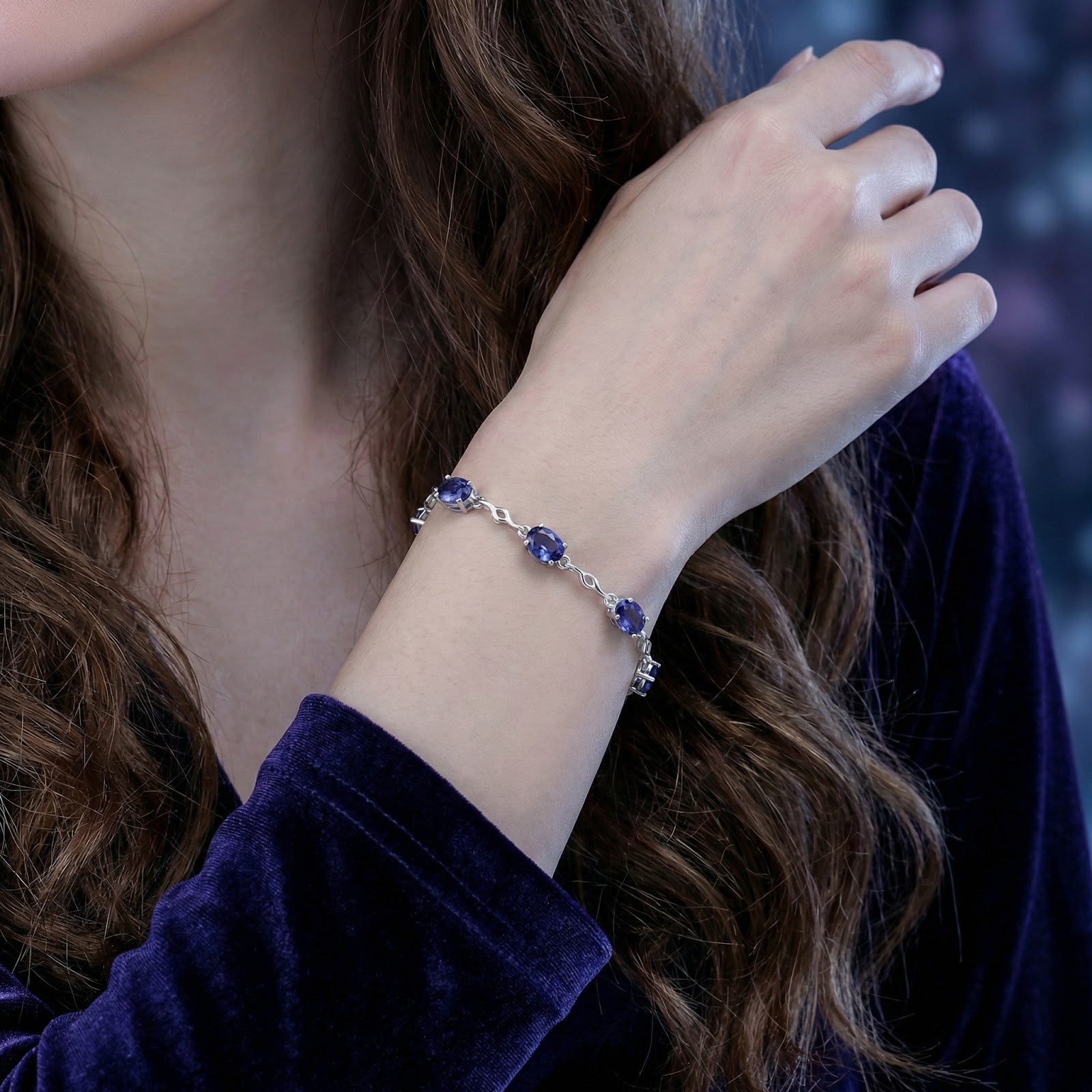 Sterling silver Melisara bracelet featuring oval-cut simulated tanzanite stones worn on a woman's wrist.