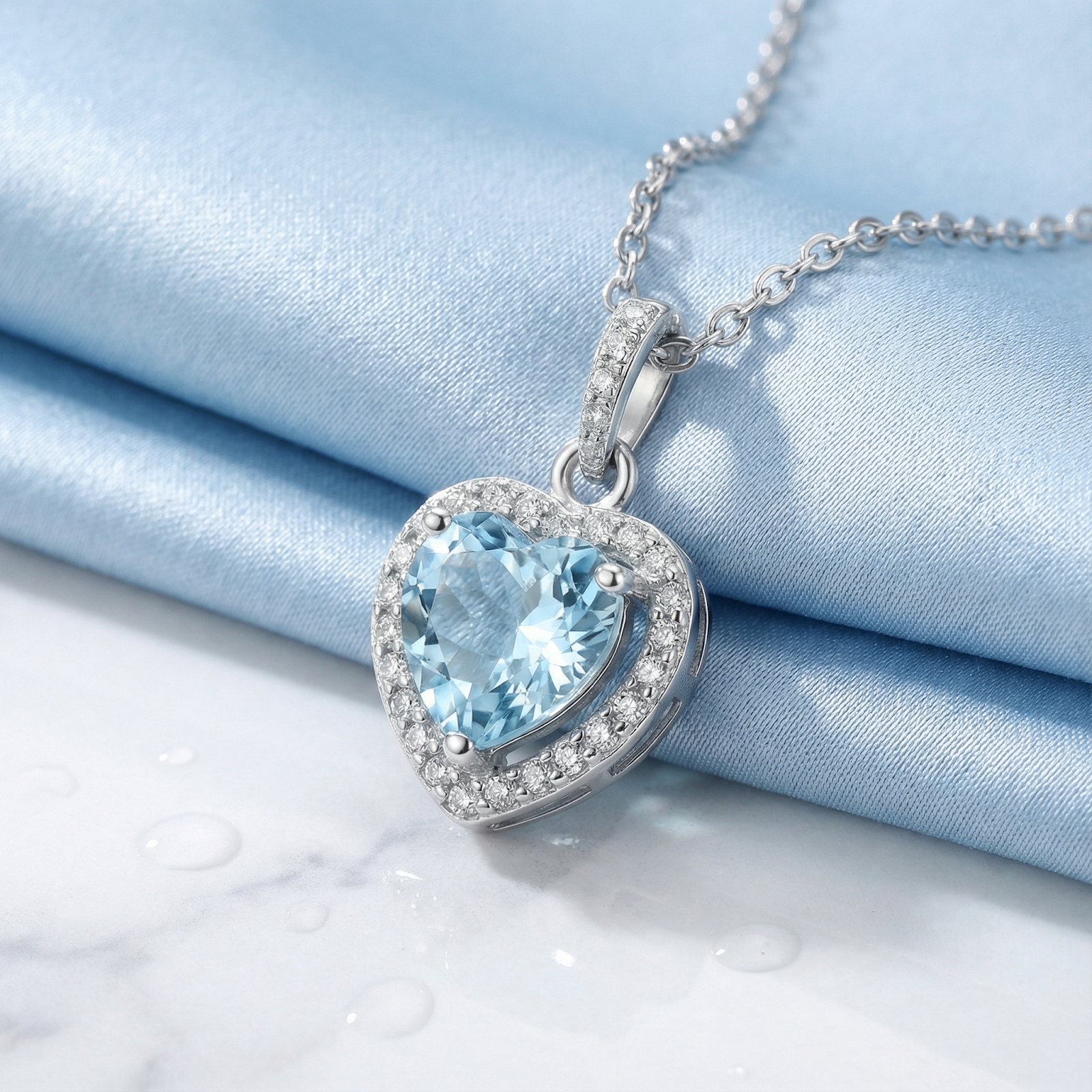 Macro view of the heart cut simulated aquamarine pendant with a halo setting in sterling silver.