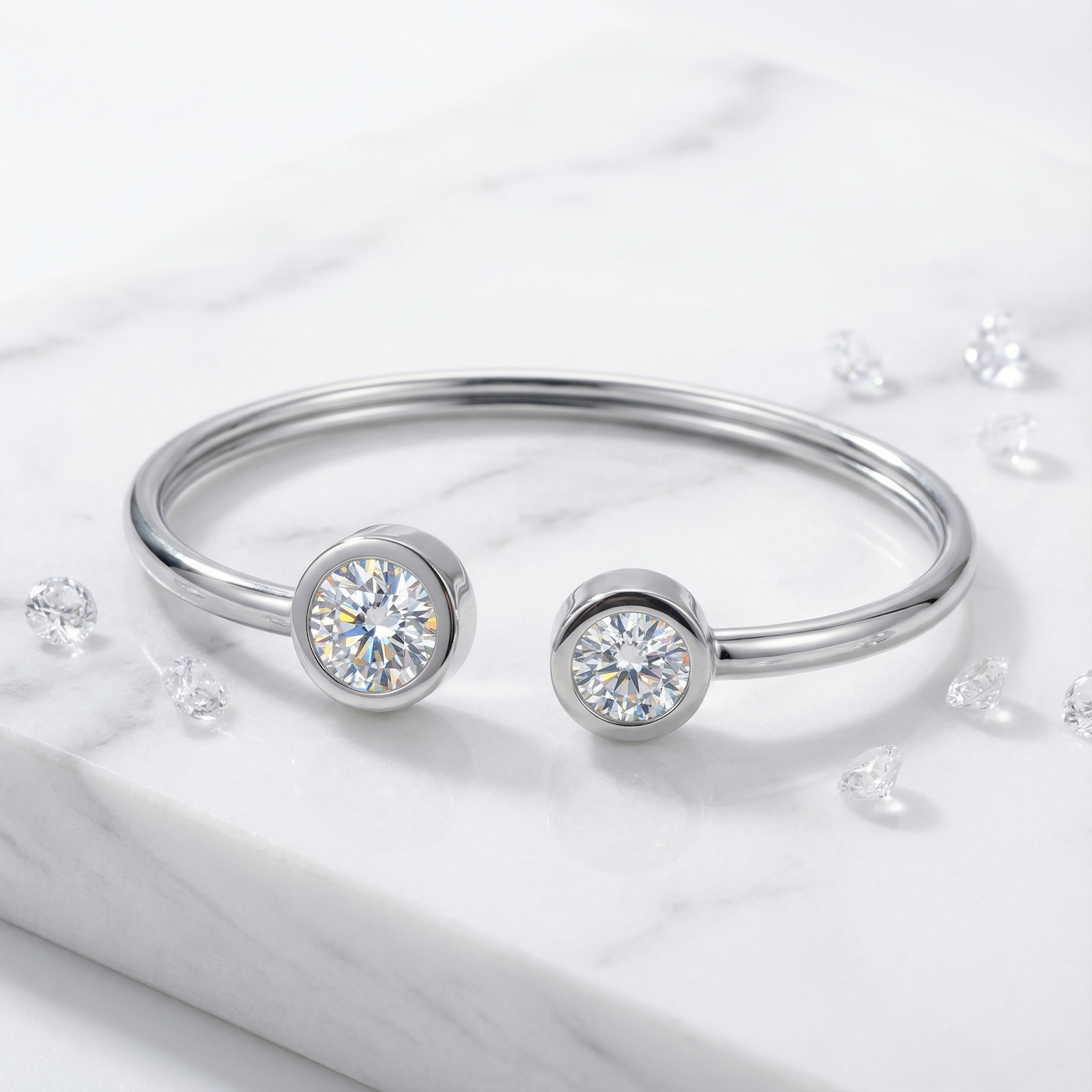 Close-up of a silver stainless steel cuff bracelet with round-cut simulated diamonds and loose stones on marble.