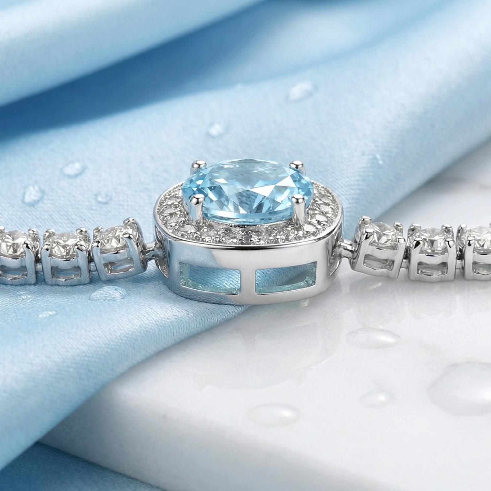 Close-up of a round simulated aquamarine in a sterling silver halo setting with clear accent stones.