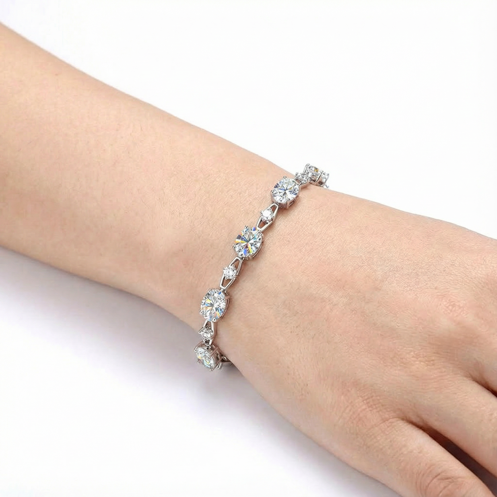 Close-up of the sterling silver oval simulated diamond bracelet worn on a woman's wrist.