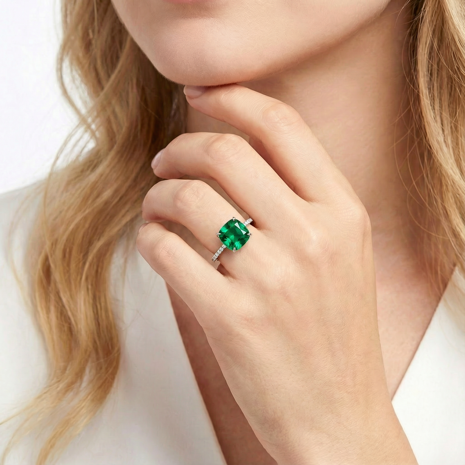 Model wearing the Serenada cushion-cut simulated emerald ring in S925 sterling silver on her ring finger.