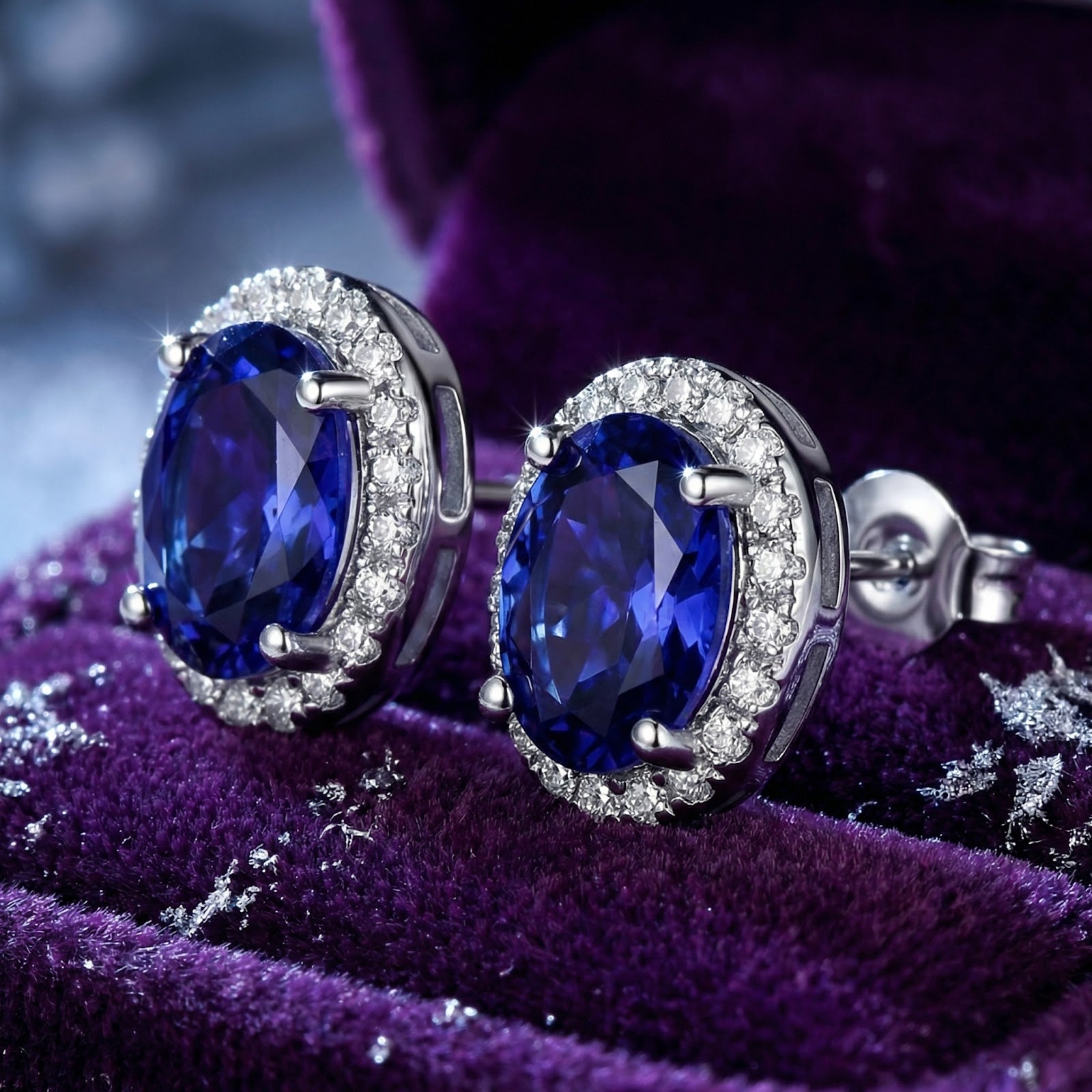 Close-up of oval simulated tanzanite halo earrings in sterling silver showing the side setting and butterfly back.