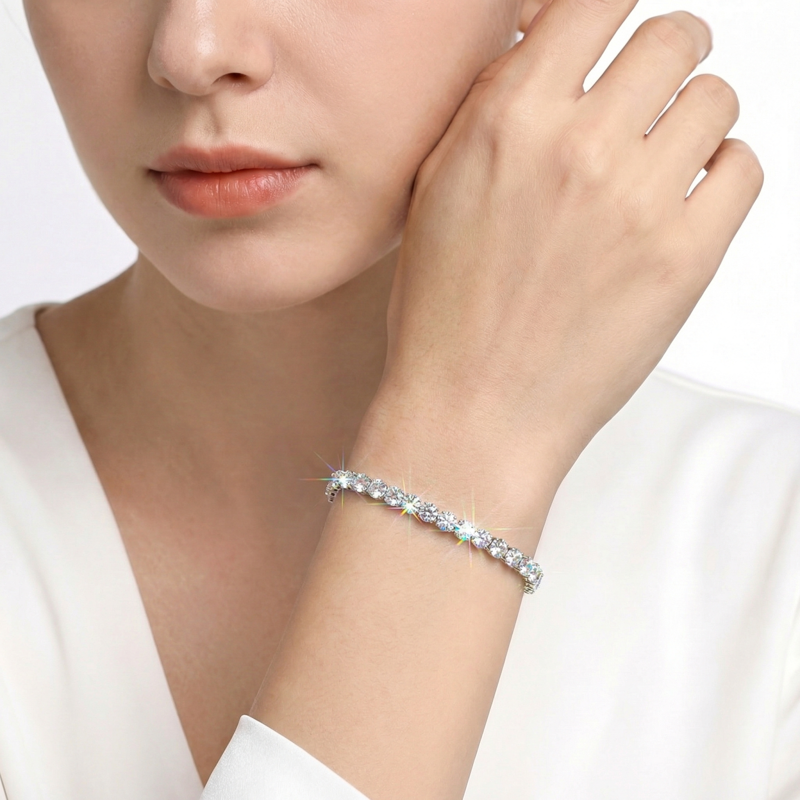 Sparkling Aris round zirconia tennis bracelet in silver stainless steel worn on a woman's wrist.