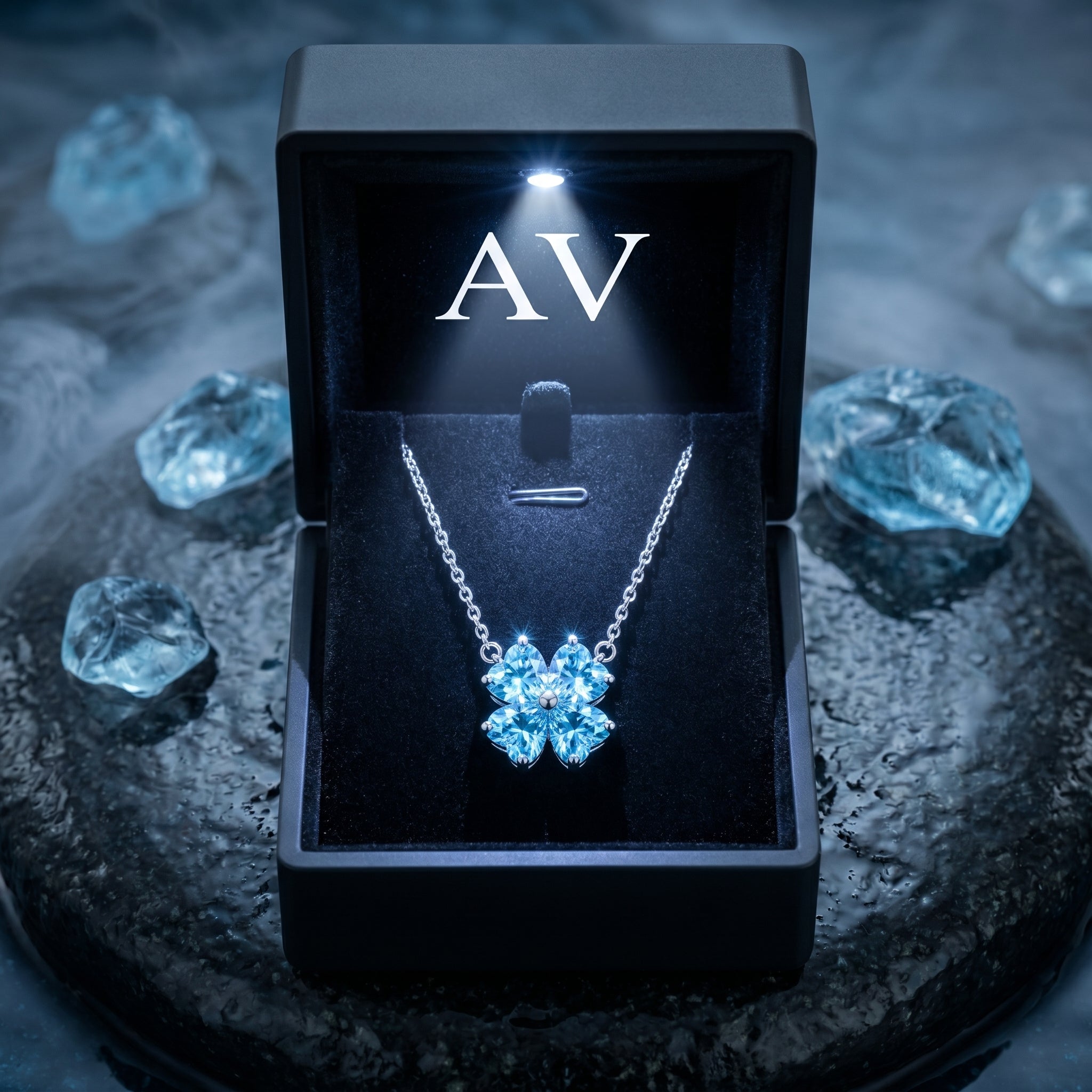Platinum aquamarine clover necklace displayed in a black lighted gift box with AV logo.