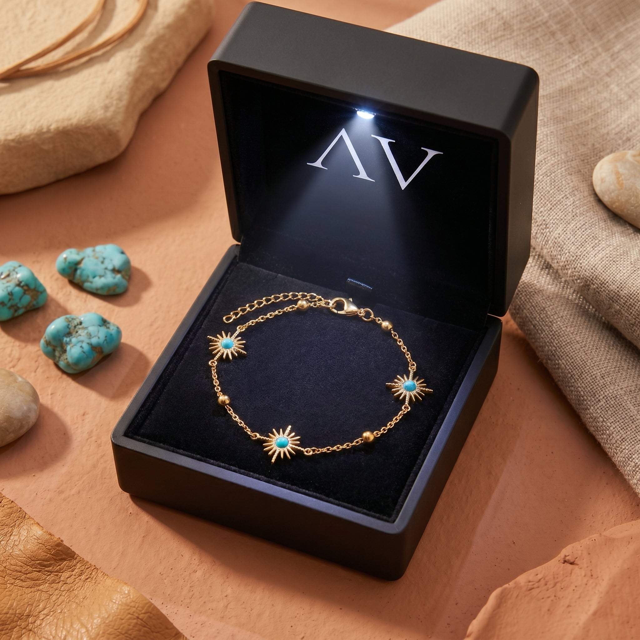 18K gold finish turquoise sunburst chain bracelet presented in a lighted black jewelry gift box.