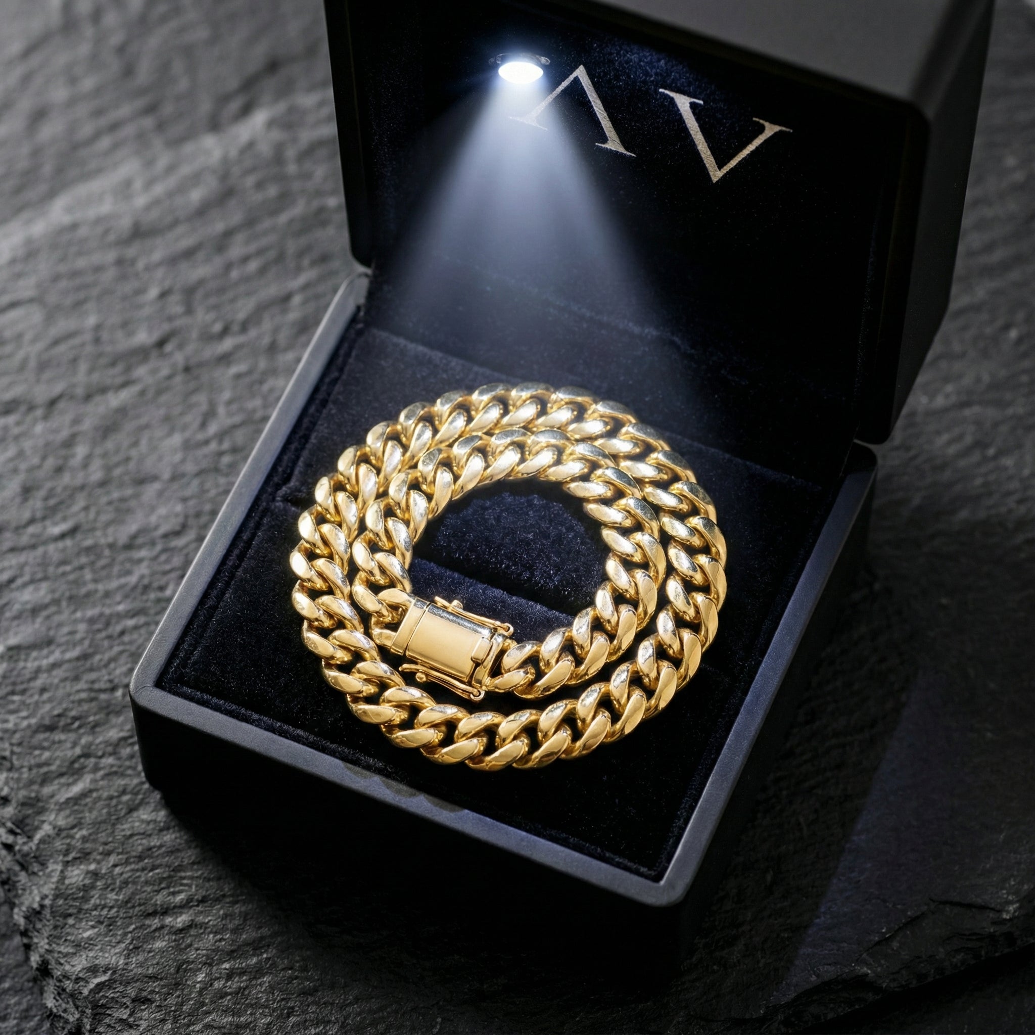8mm gold stainless steel Cuban link bracelet presented in a black lighted jewelry gift box.