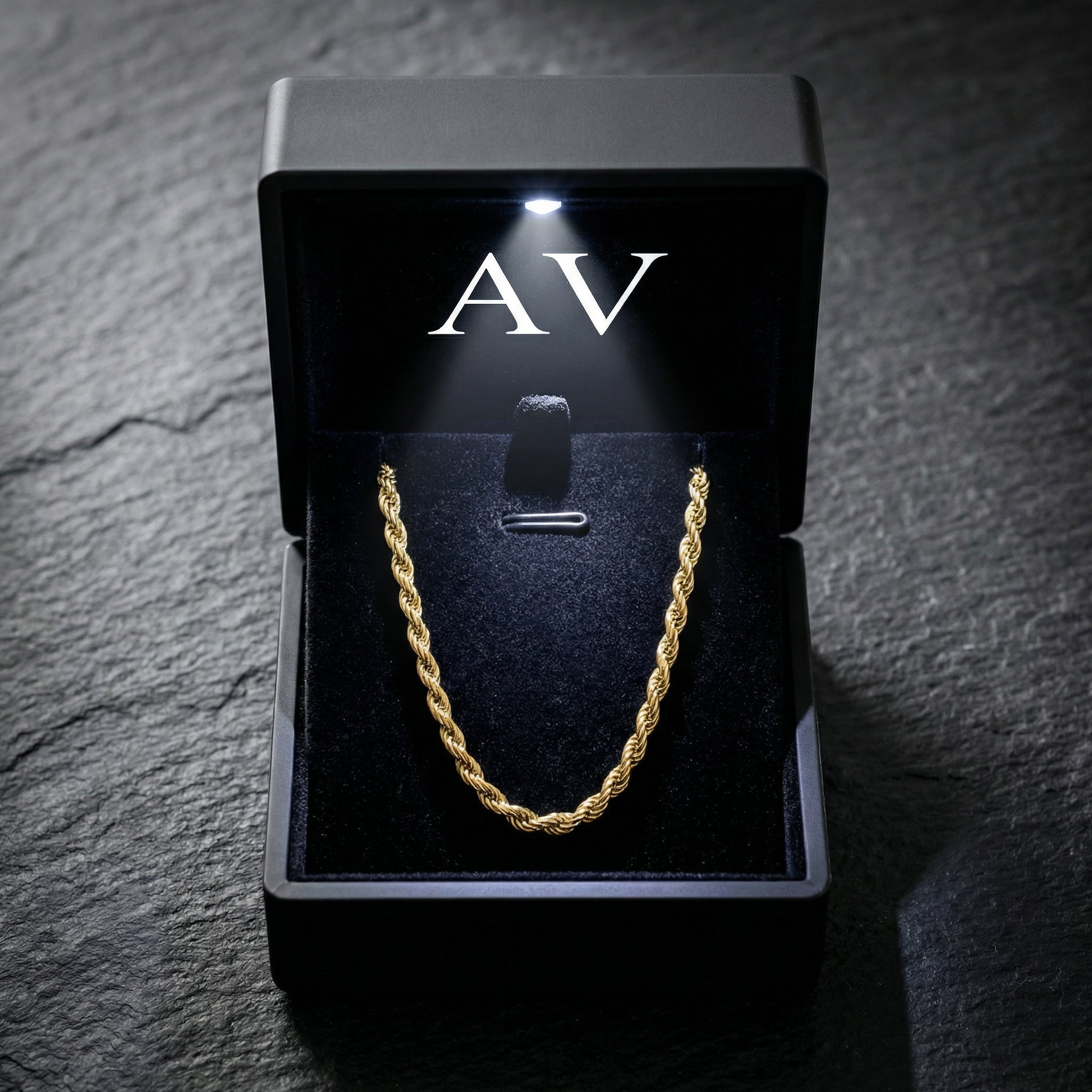 Gold stainless steel rope chain presented in a black LED-lighted jewelry box with AV branding.