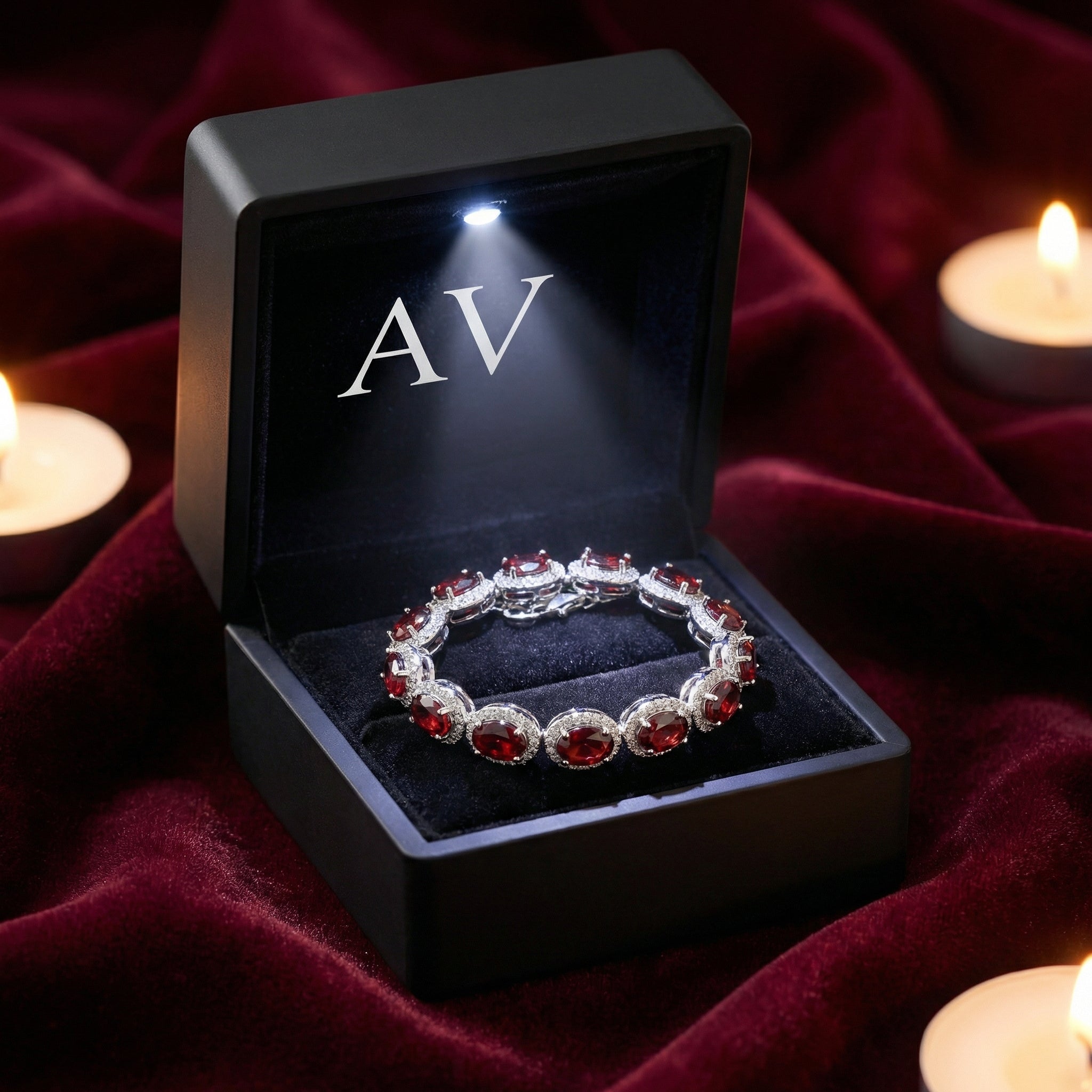Cassia halo bracelet with red simulated garnets in a black LED-lit jewelry box on red velvet.