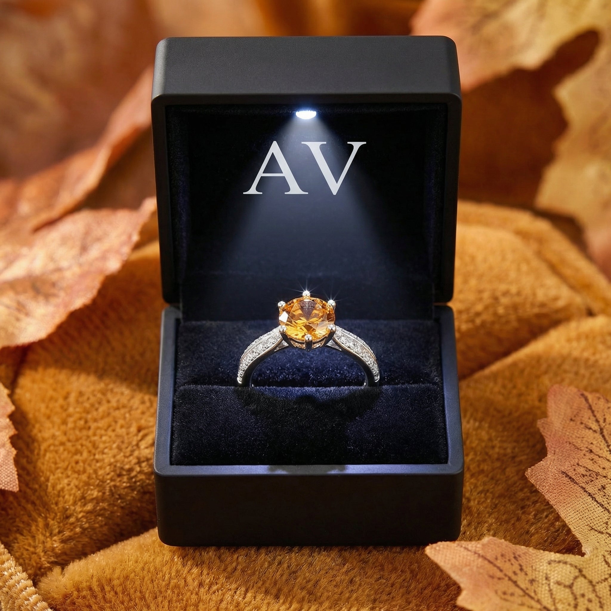 Round simulated topaz sterling silver ring presented in a black LED-lit jewelry gift box.