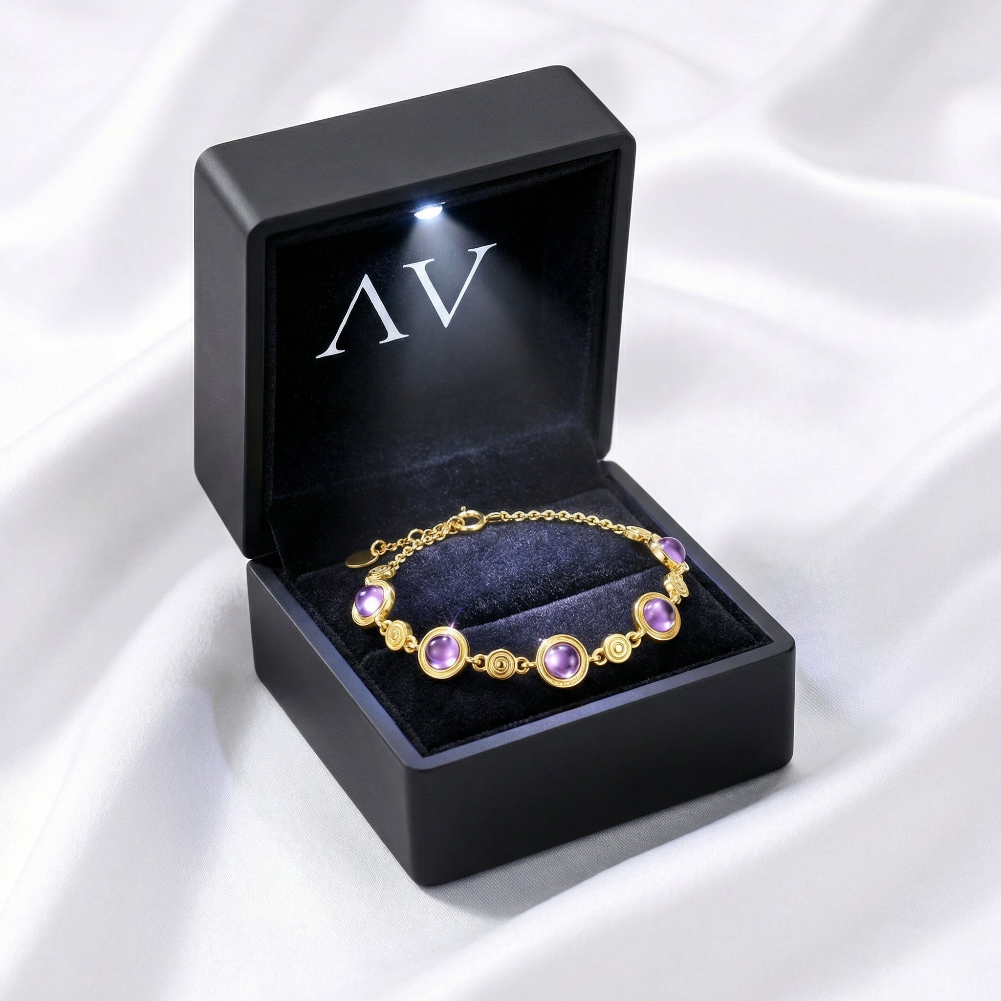 18K gold vermeil simulated amethyst station bracelet inside a black LED-lighted jewelry presentation box.