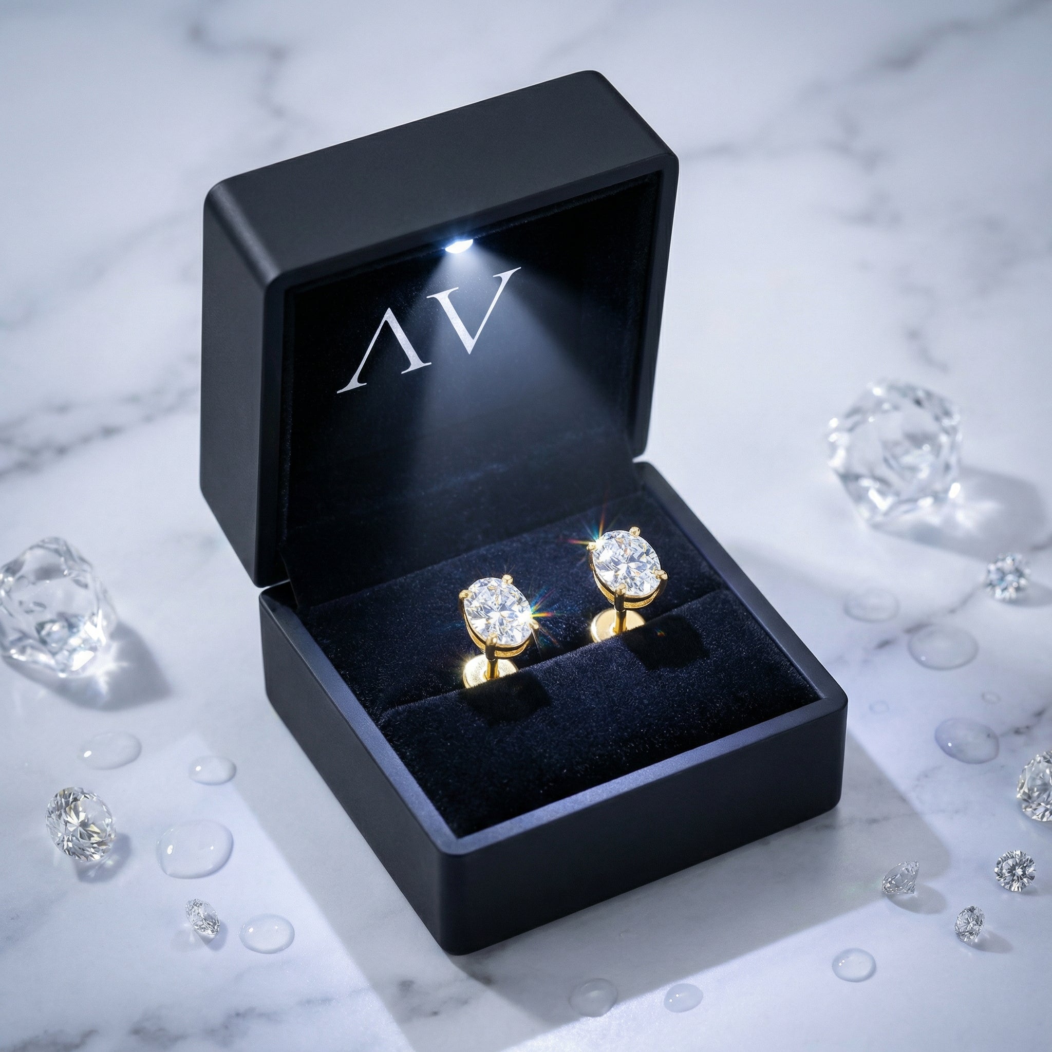 18K gold vermeil oval zirconia stud earrings inside a black premium lighted gift box.