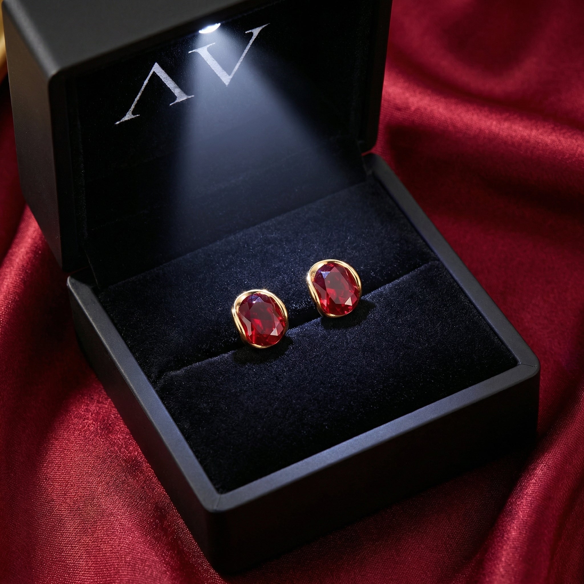 18K gold vermeil simulated ruby stud earrings presented in a premium lighted black jewelry box.