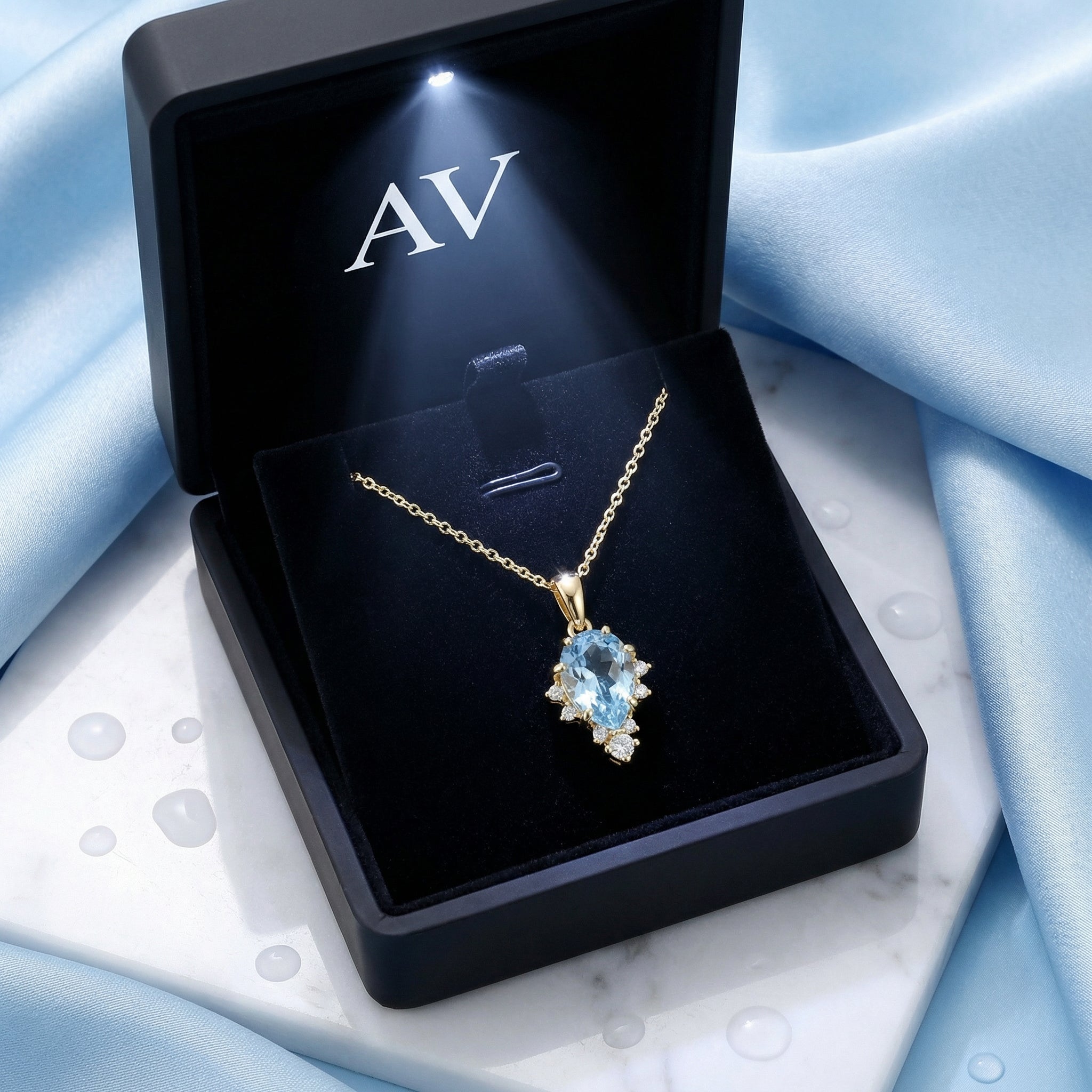 March birthstone simulated aquamarine necklace in a lighted black jewelry presentation box.