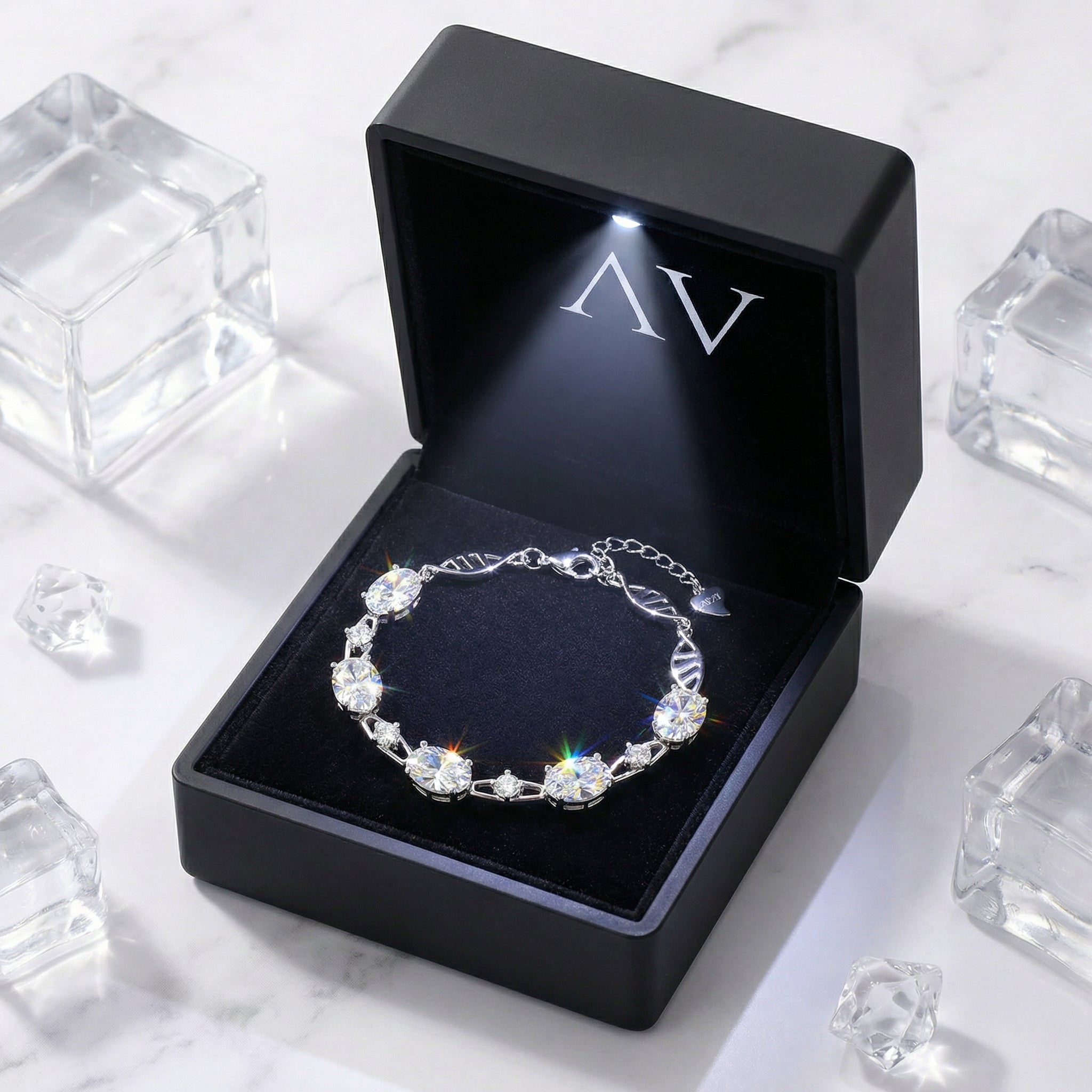 Silver oval simulated diamond bracelet presented in a black LED-lit jewelry gift box.