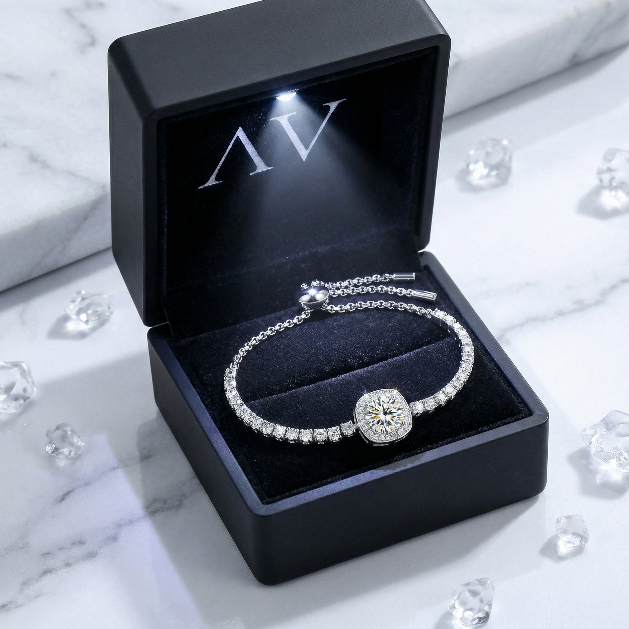 Sterling silver halo bracelet with a simulated diamond presented in a luxury black LED-lit gift box.