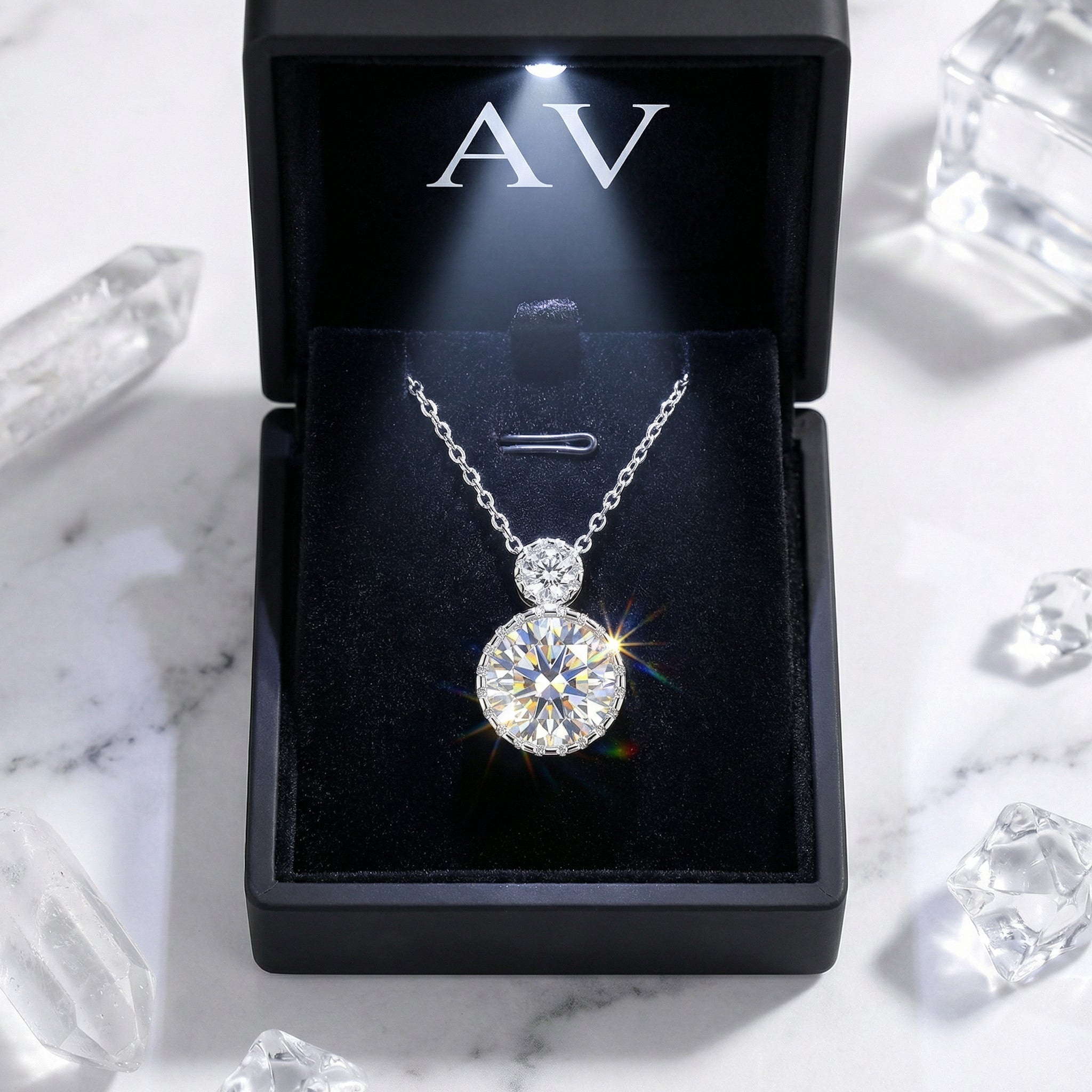 Sterling silver simulated diamond pendant presented in a black LED-lit gift box with crystals.