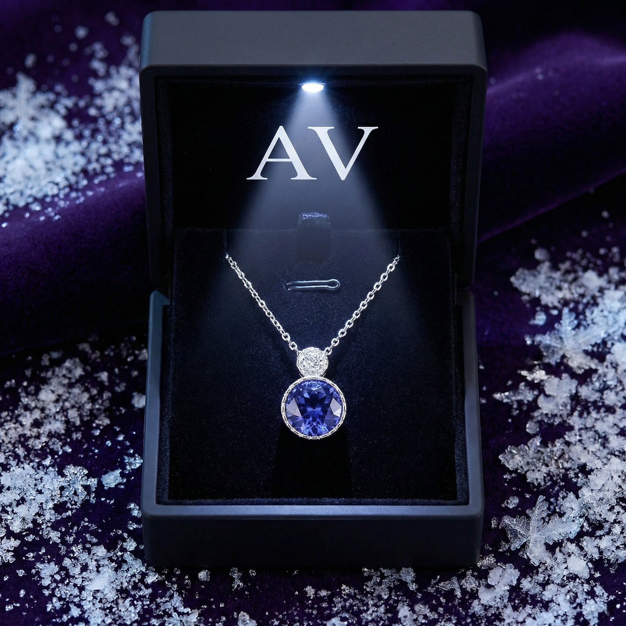 Sterling silver simulated tanzanite drop necklace in a lighted AV branded jewelry box with decorative snow.