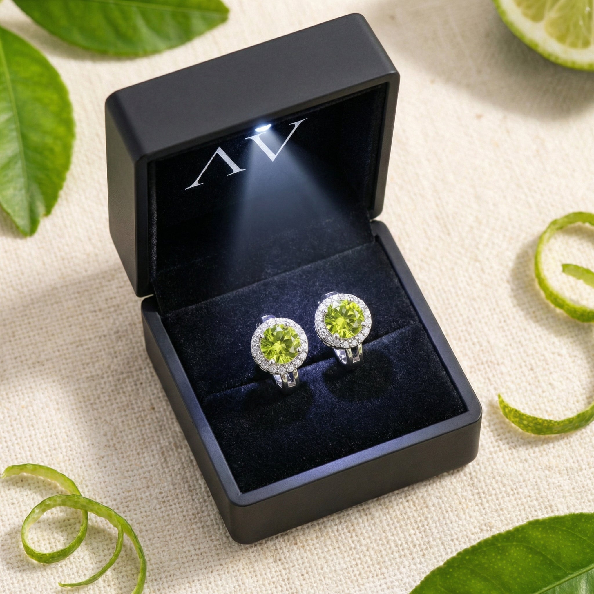 Green moissanite halo earrings in S925 sterling silver presented in a premium black LED-lit gift box.