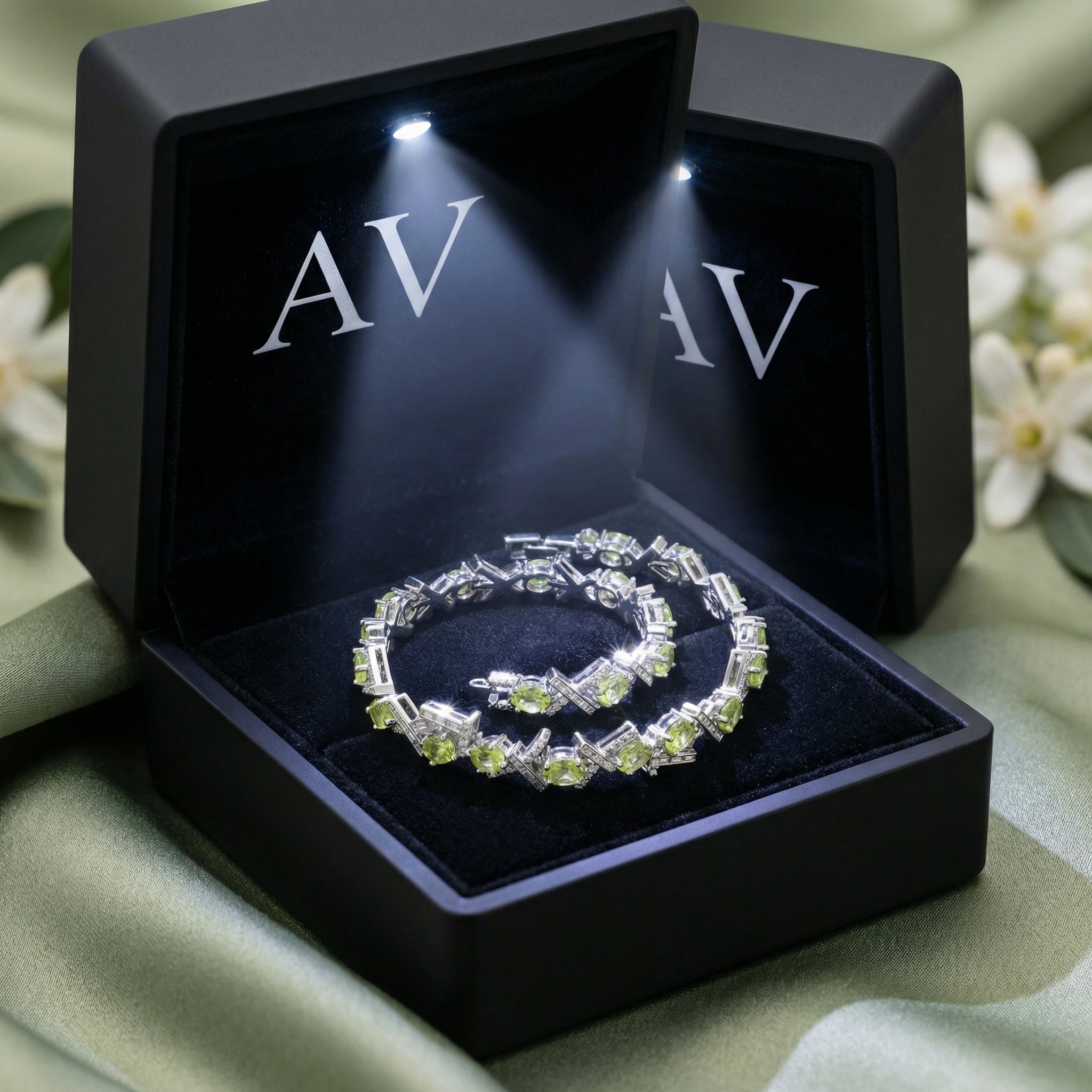 Oval cut green peridot sterling silver bracelet presented in a black LED-lit jewelry gift box.