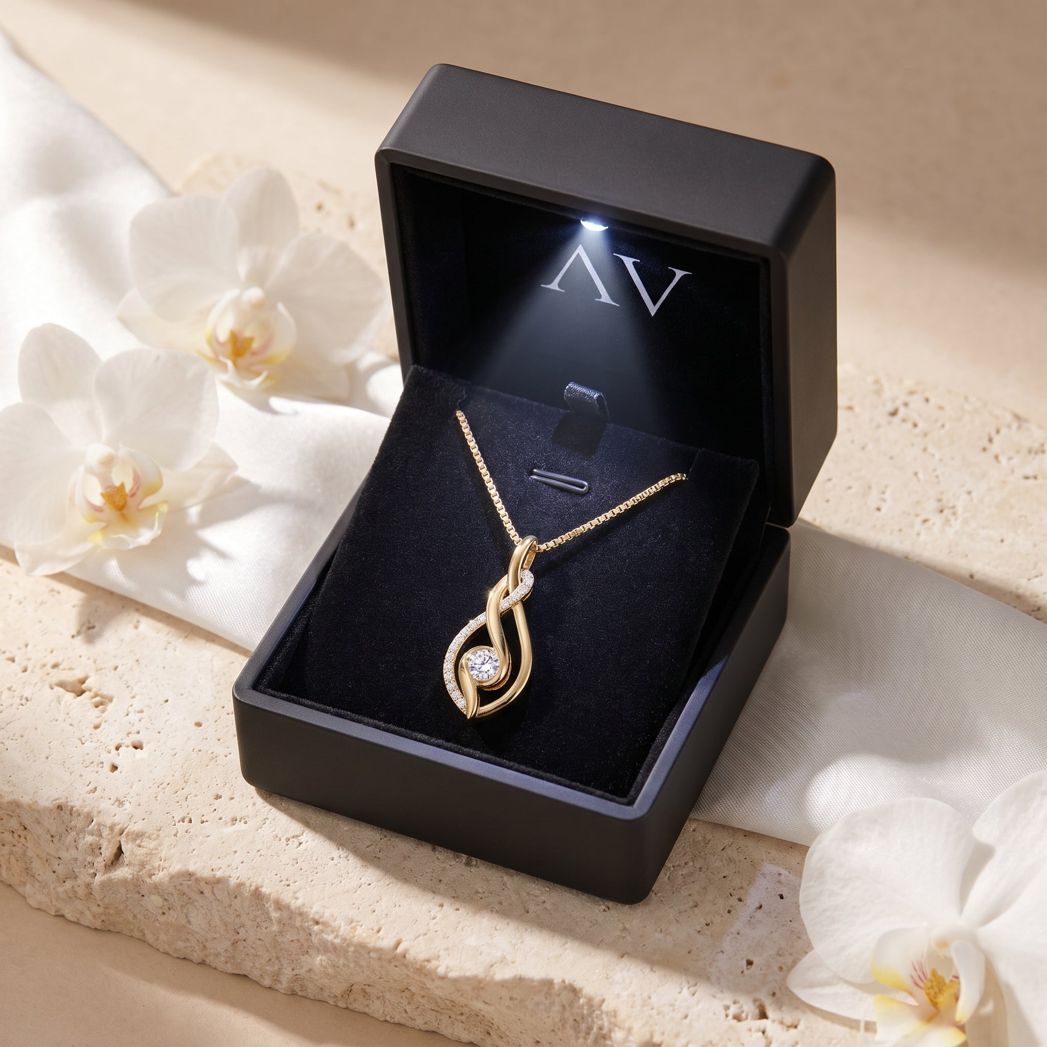 Yellow gold moissanite pendant inside a black LED-lit presentation box.