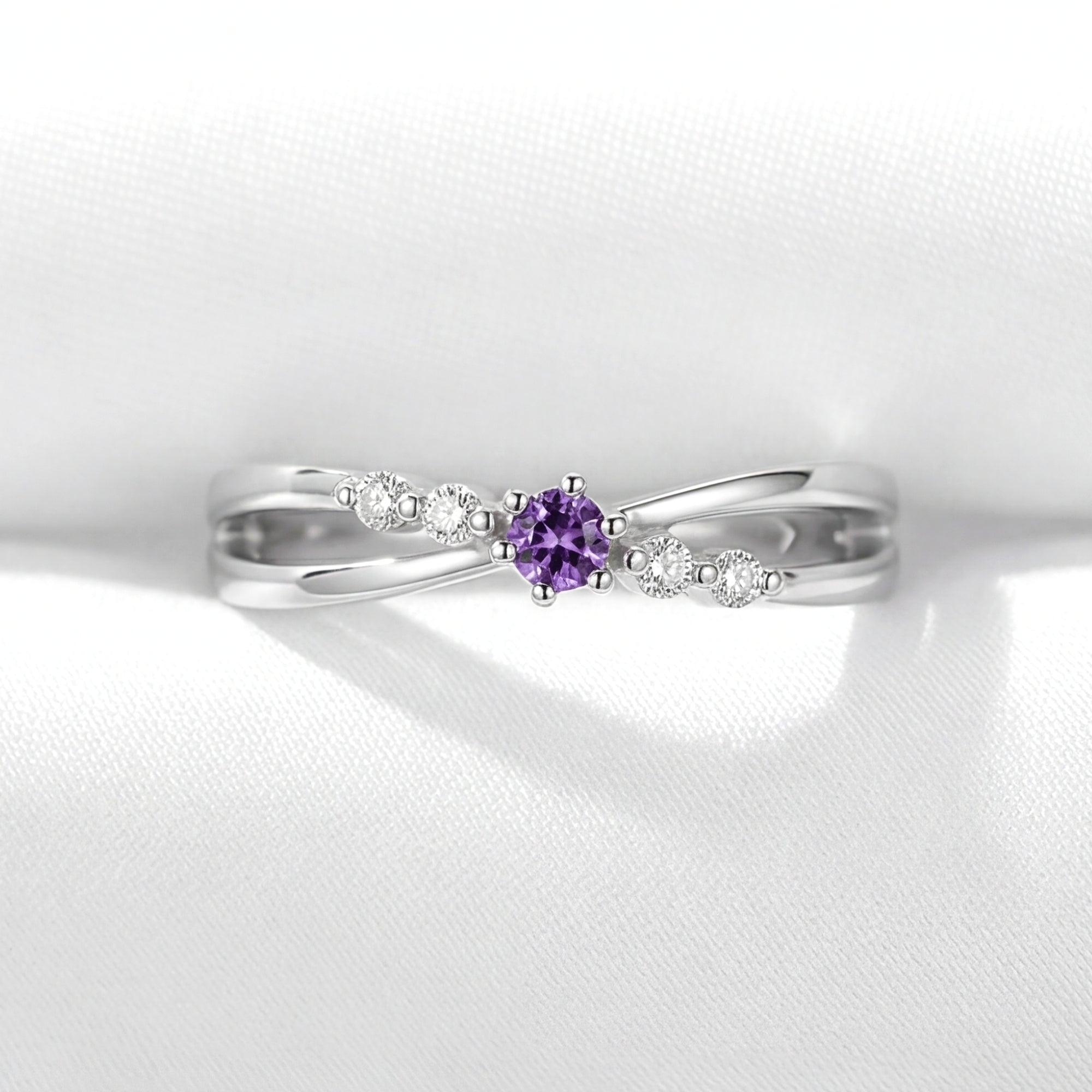 Front view of the Astraea round simulated amethyst ring in S925 sterling silver on white fabric.