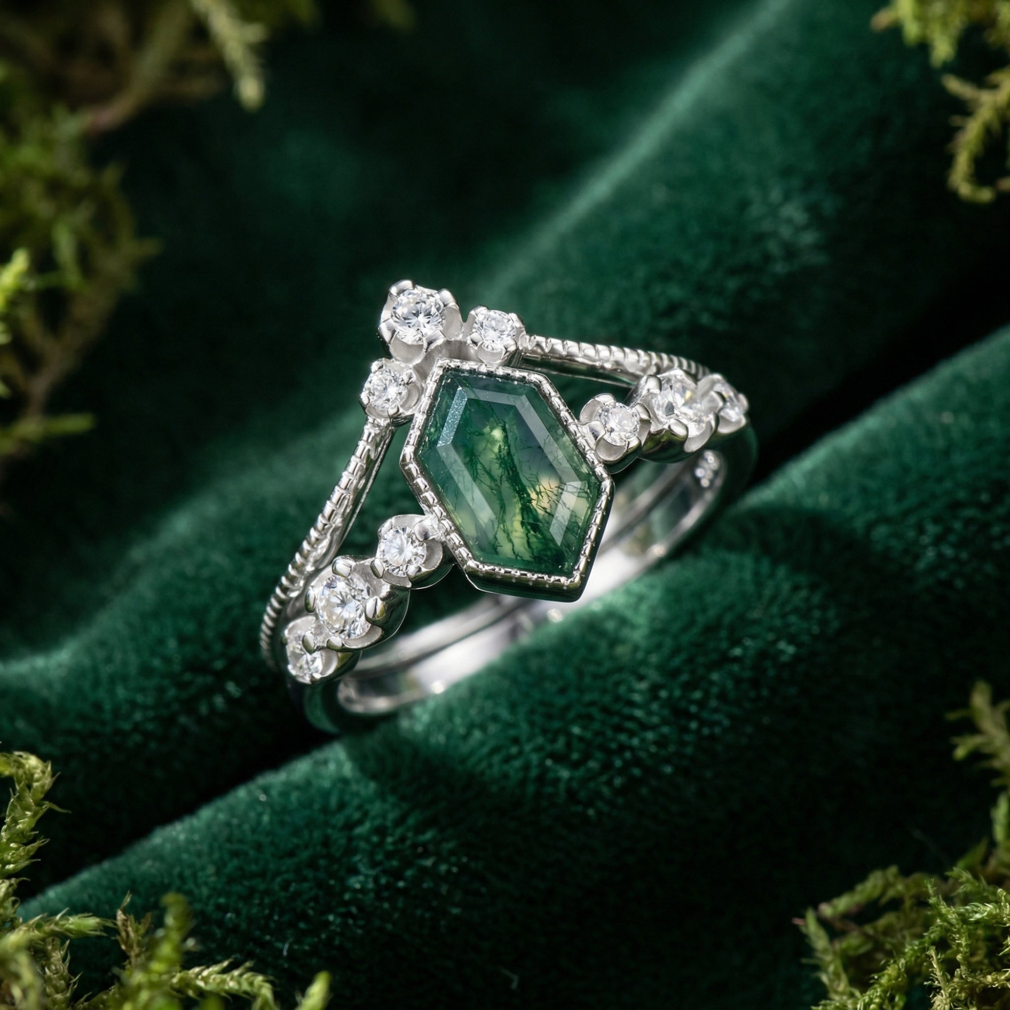 Kite cut moss agate and diamond ring duo in sterling silver on a green velvet background with moss.