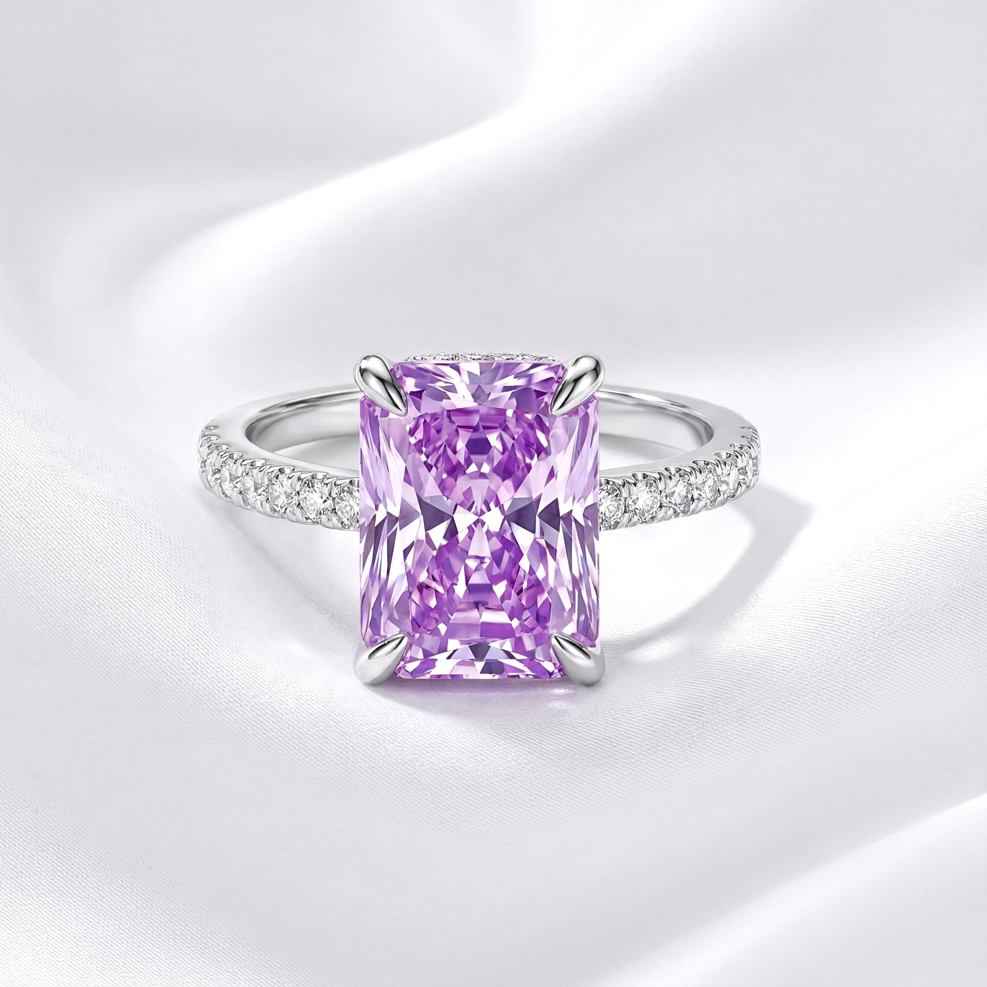 Radiant cut purple simulated amethyst ring in S925 sterling silver on a white silk background.