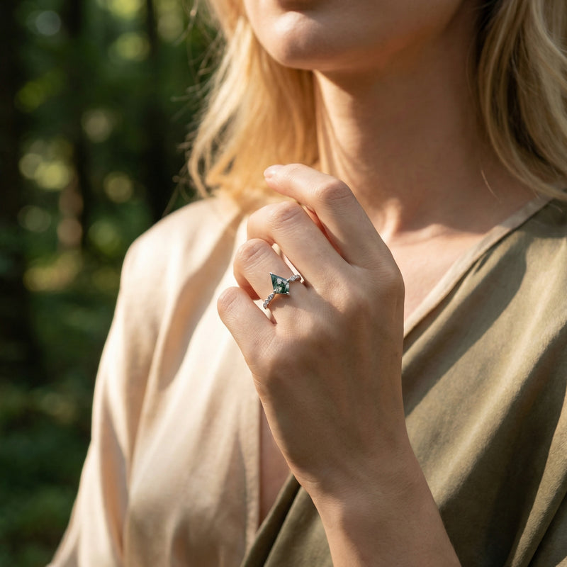 Model wearing a kite cut natural moss agate twisted diamond ring in sterling silver outdoors.