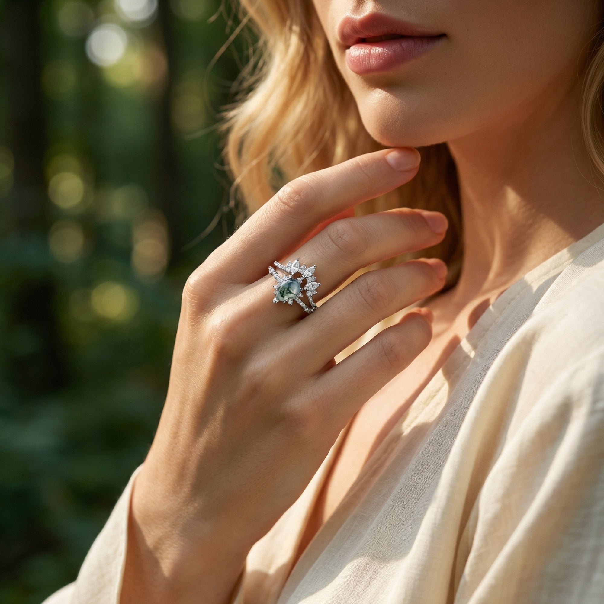 Model wearing the frosted kite cut moss agate and marquise diamond silver ring set outdoors.
