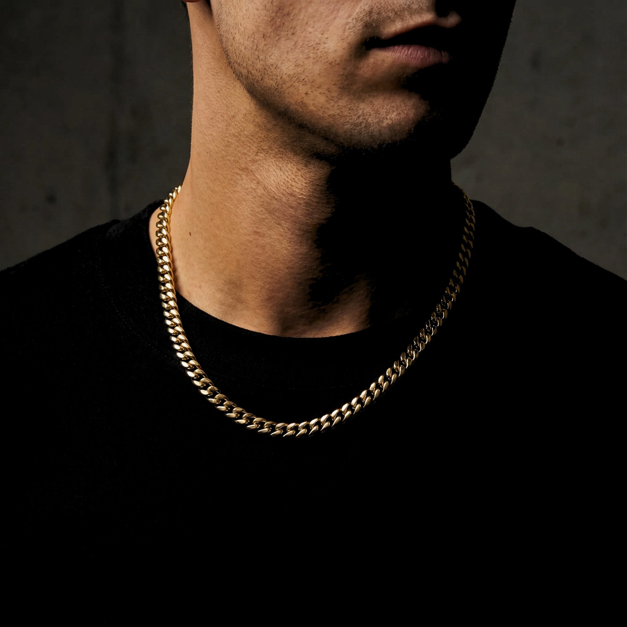 8mm gold Cuban chain in stainless steel worn by a man, showcasing the necklace length.